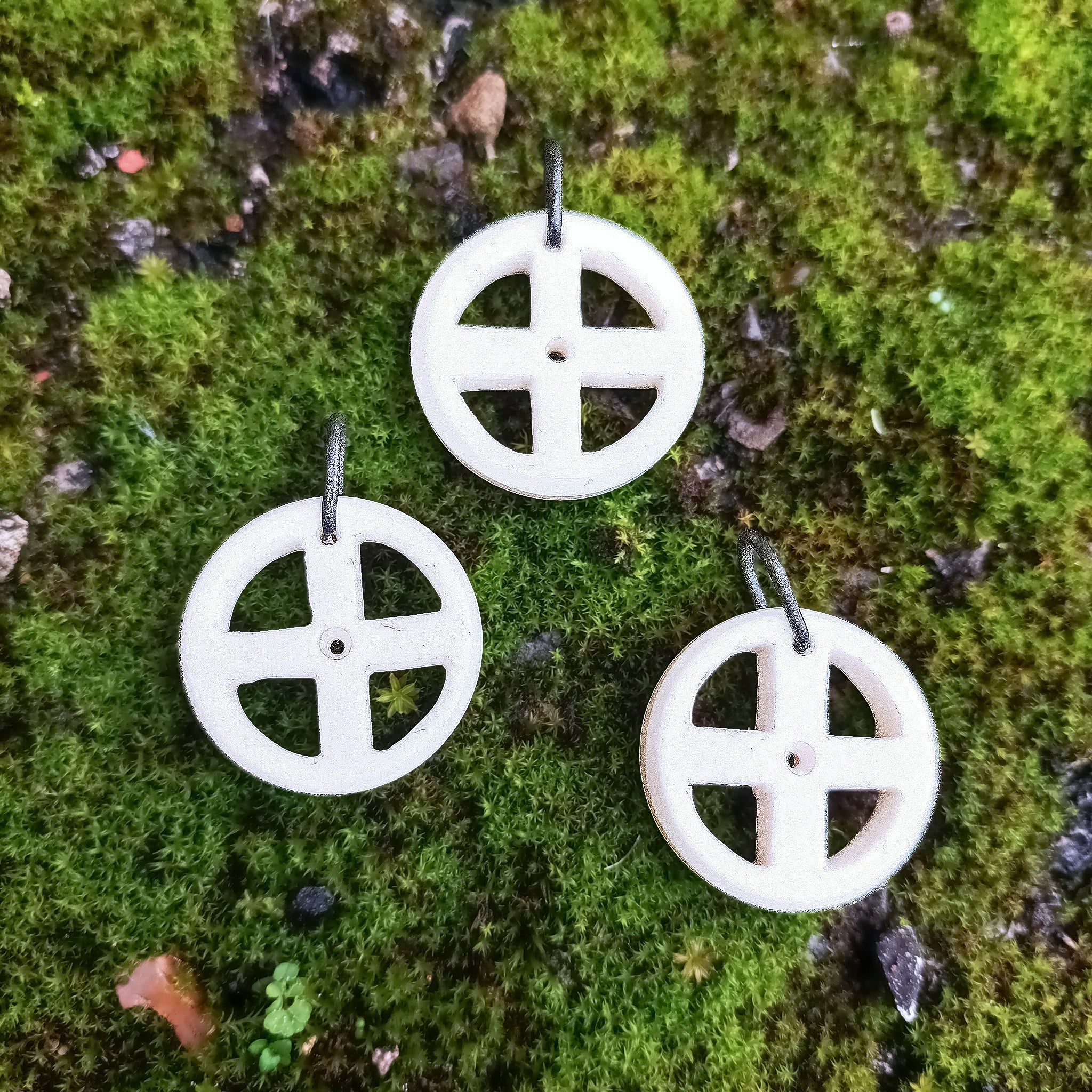 Bone Sun Cross Odin Pendants on Moss