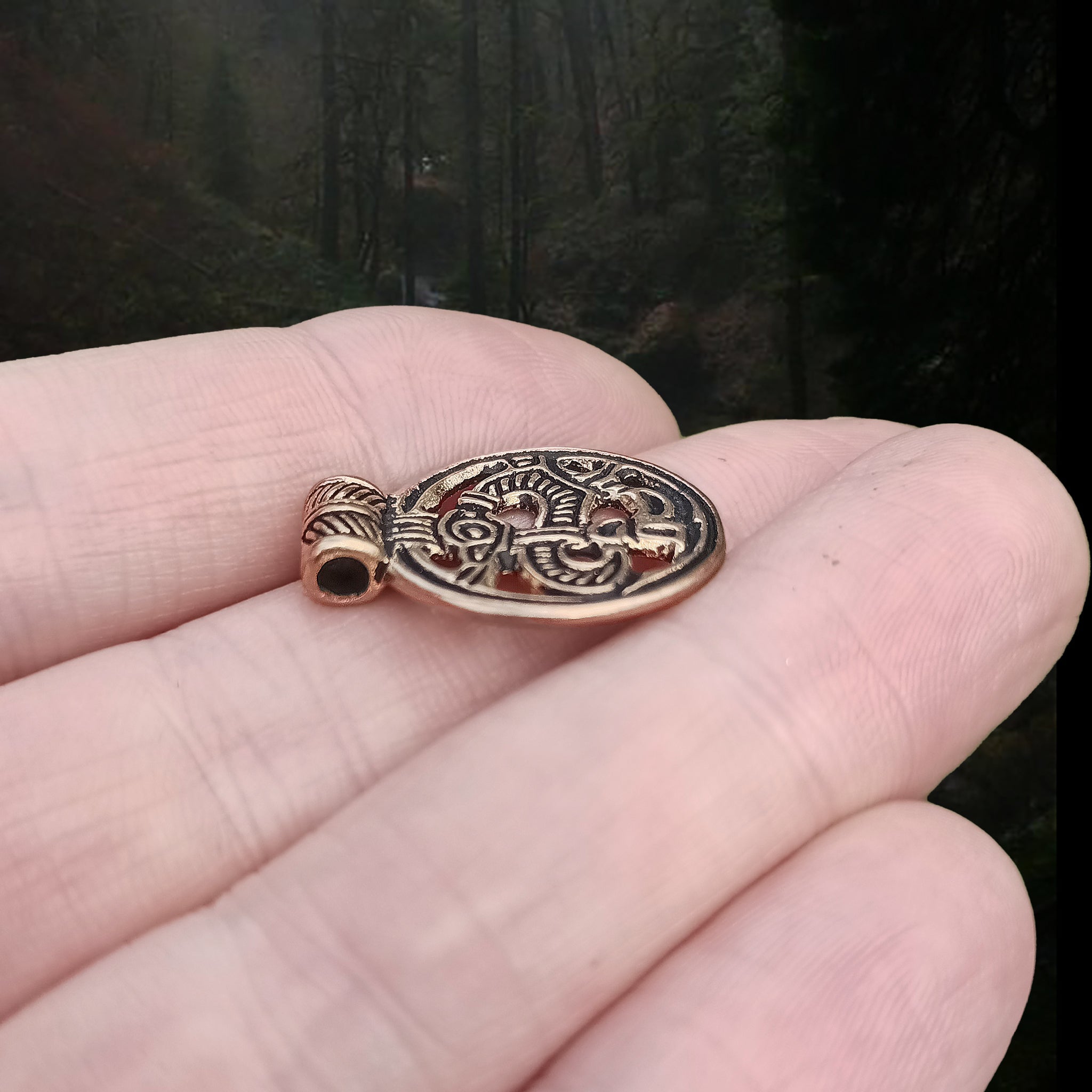 Round Bronze Viking Dragon Pendant from Birka on Hand - Side Angle View