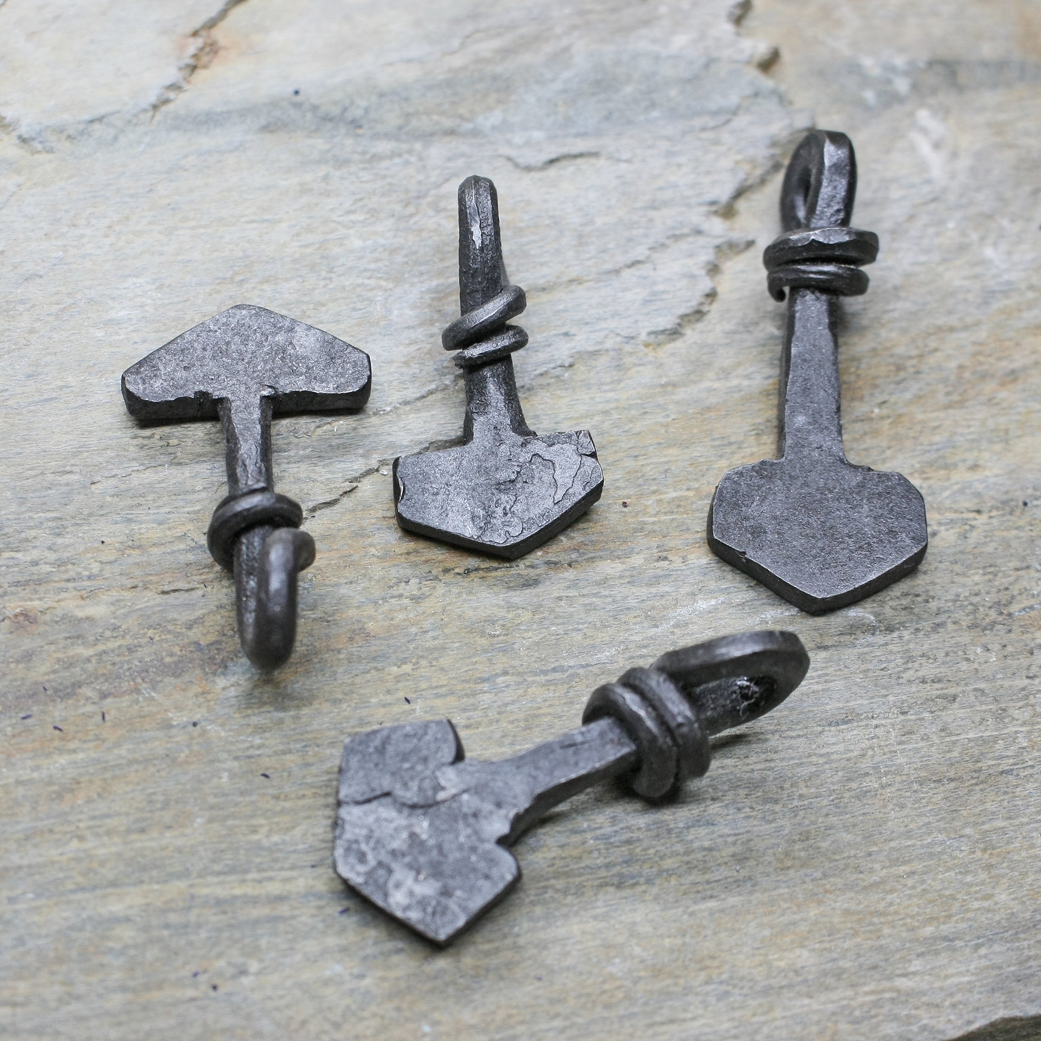 Small Iron Thors Hammer Pendants on Rock