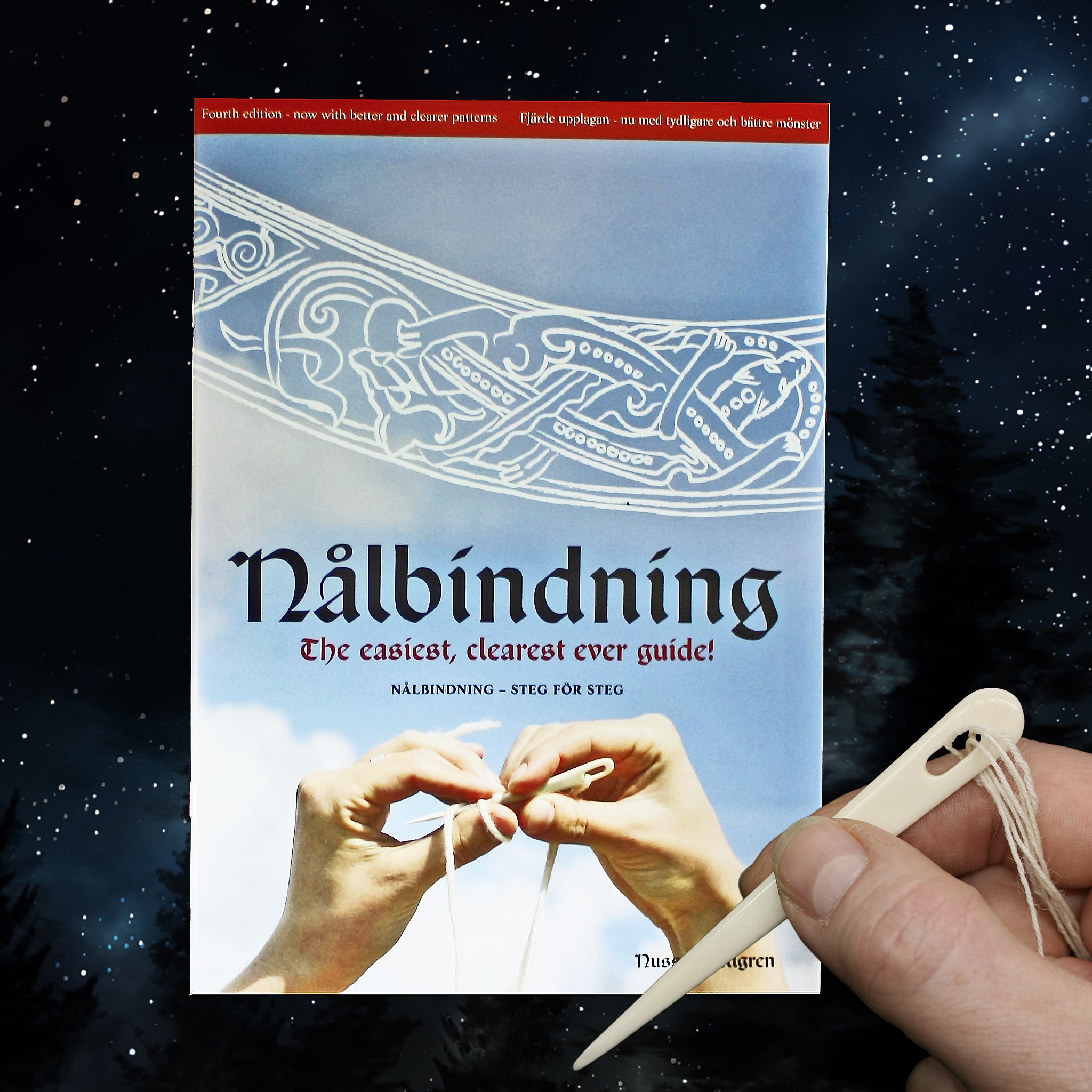 Nalbinding Instruction Book with Bone Nalbinding Needle in Hand on Starry Sky Background