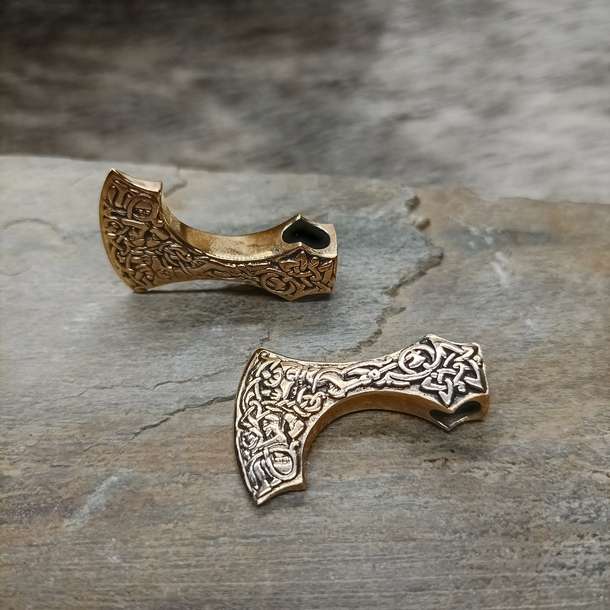 Bronze Bearded Axe Head Pendants on Rock