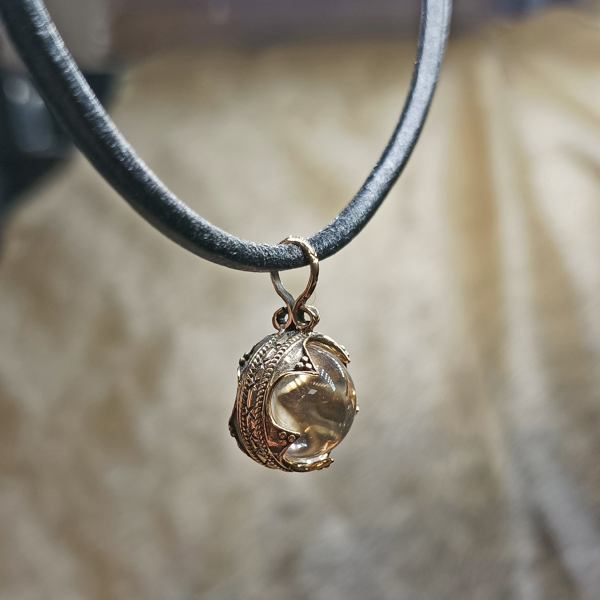 Small Bronze Gotland Crystal Ball Pendant on Leather Thong - Side View