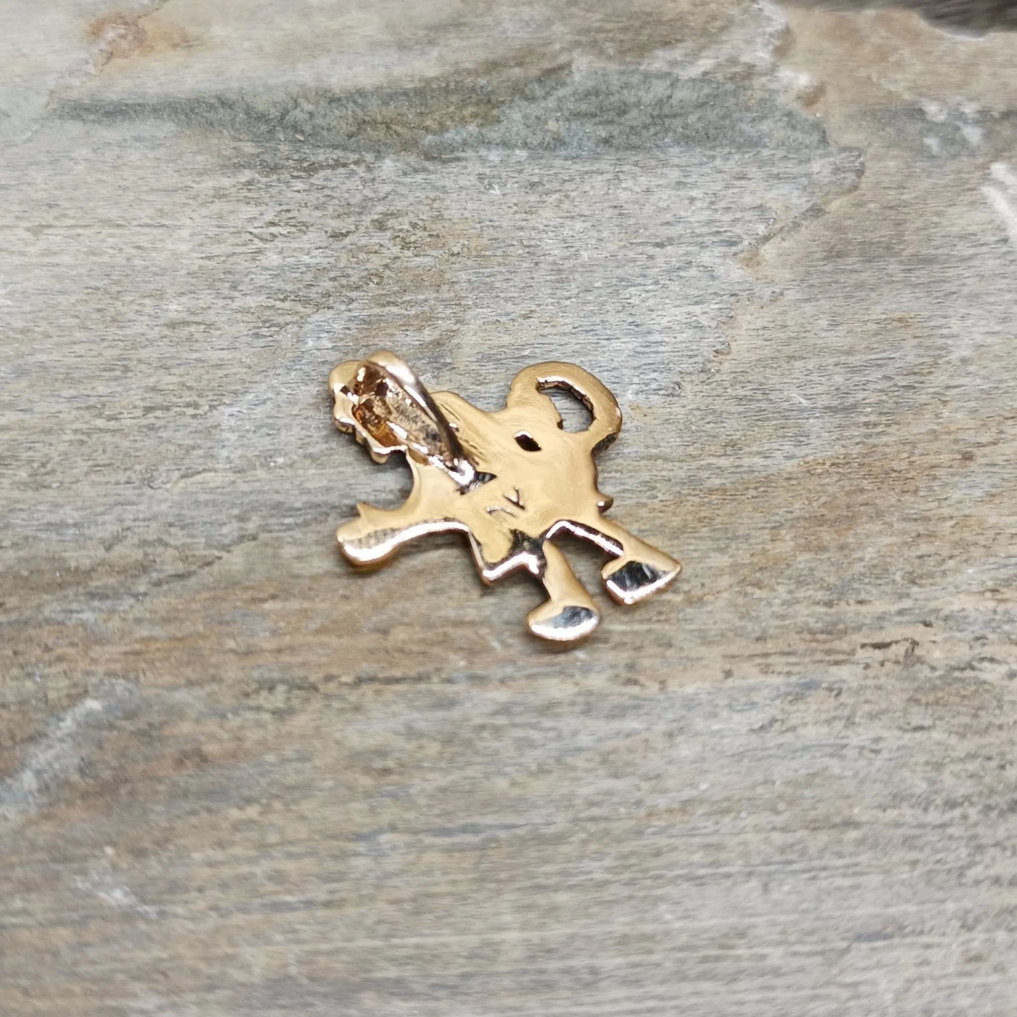 Bronze Fafnir Viking Pendant on Rock - Back Angle View