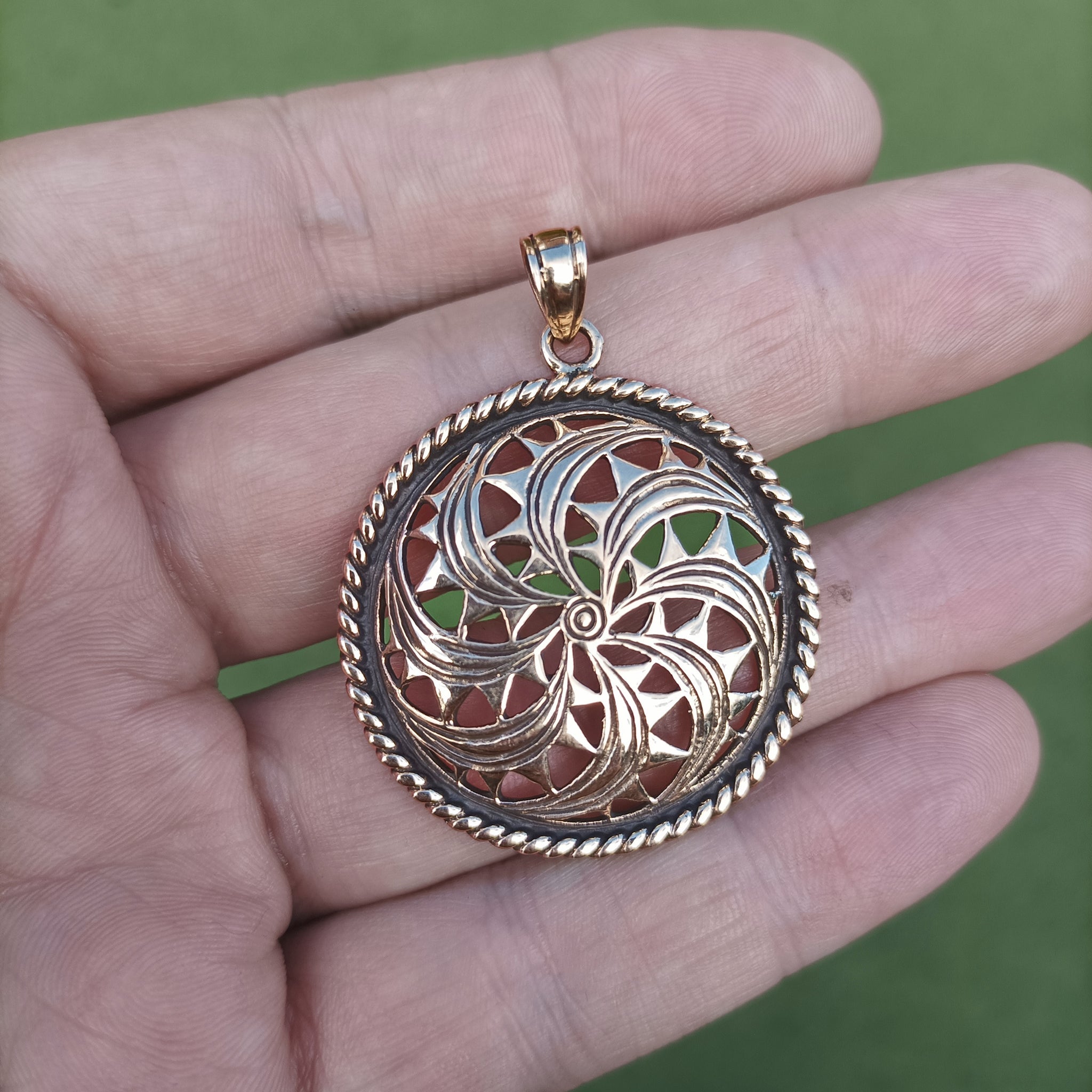 Large Bronze Sun Wheel Pendant on Hand