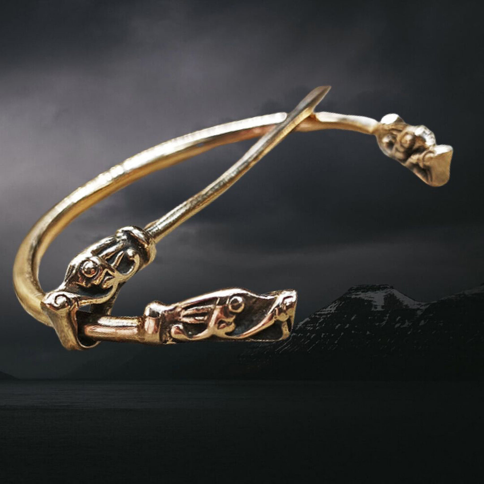 Bronze Penannular Brooch with Gotlandic Dragon Heads on Night Skies Background