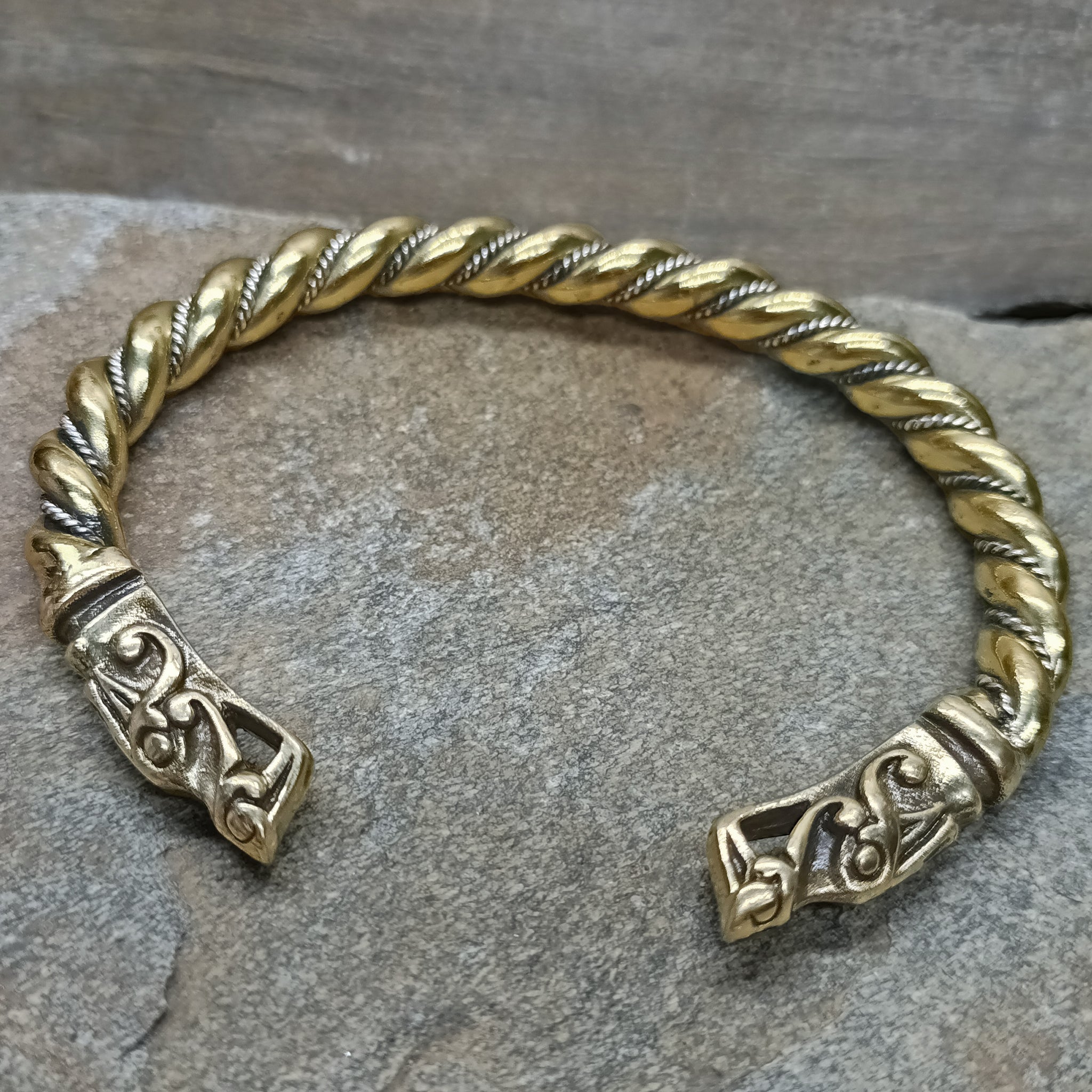 Twisted Bronze and Silver Bracelet With Gotlandic Dragon Heads on Rock - Front Angle View