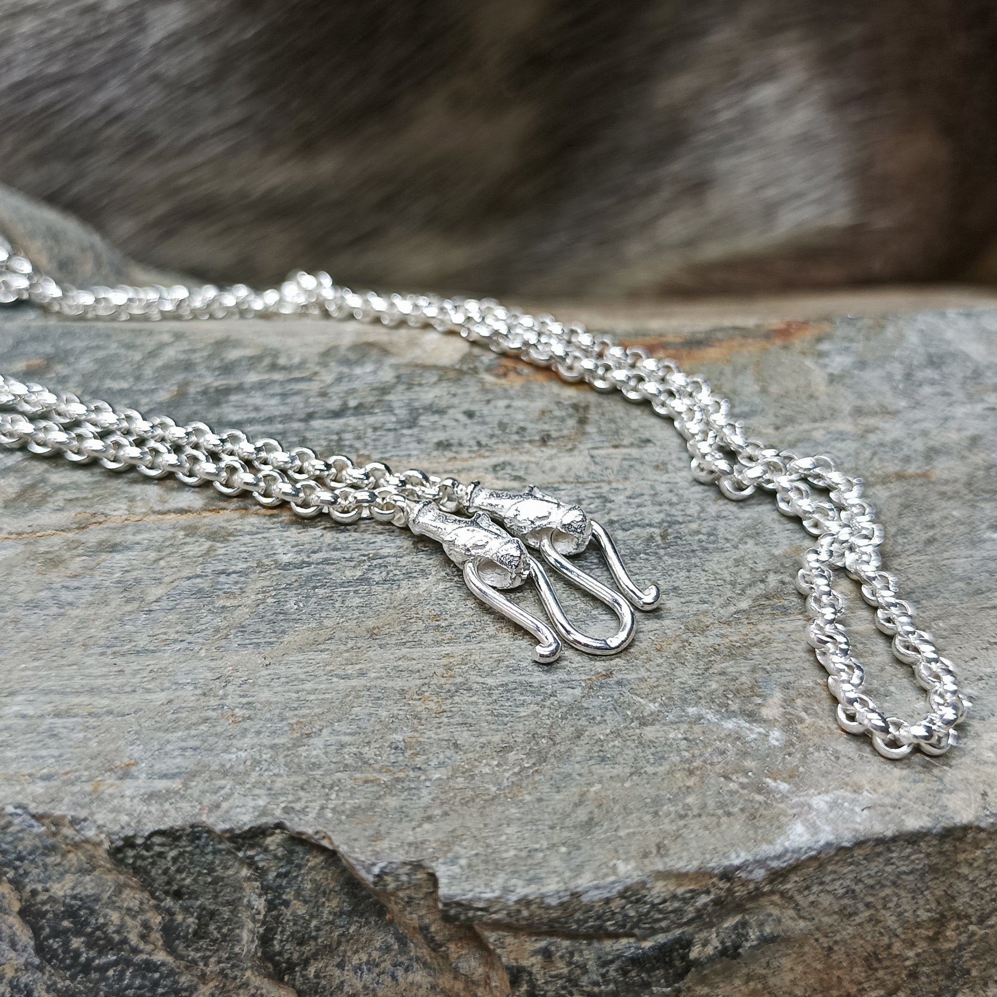 Sterling Silver Viking Necklace with Icelandic Wolf Heads and Anchor Chain Holding Silver Buttefly Fitting on Rock