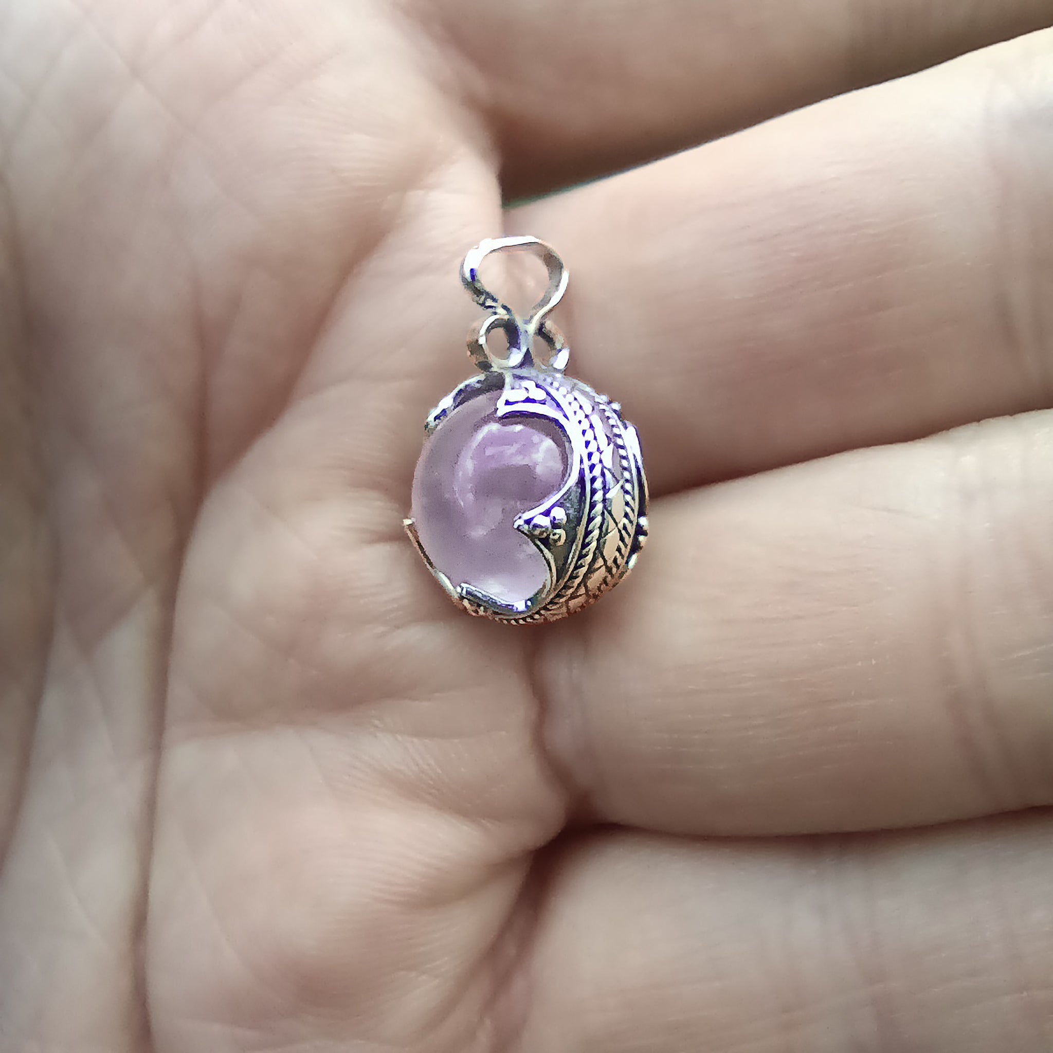 Small Silver Gotland Rose Quartz Ball Pendant in Hand - Side View