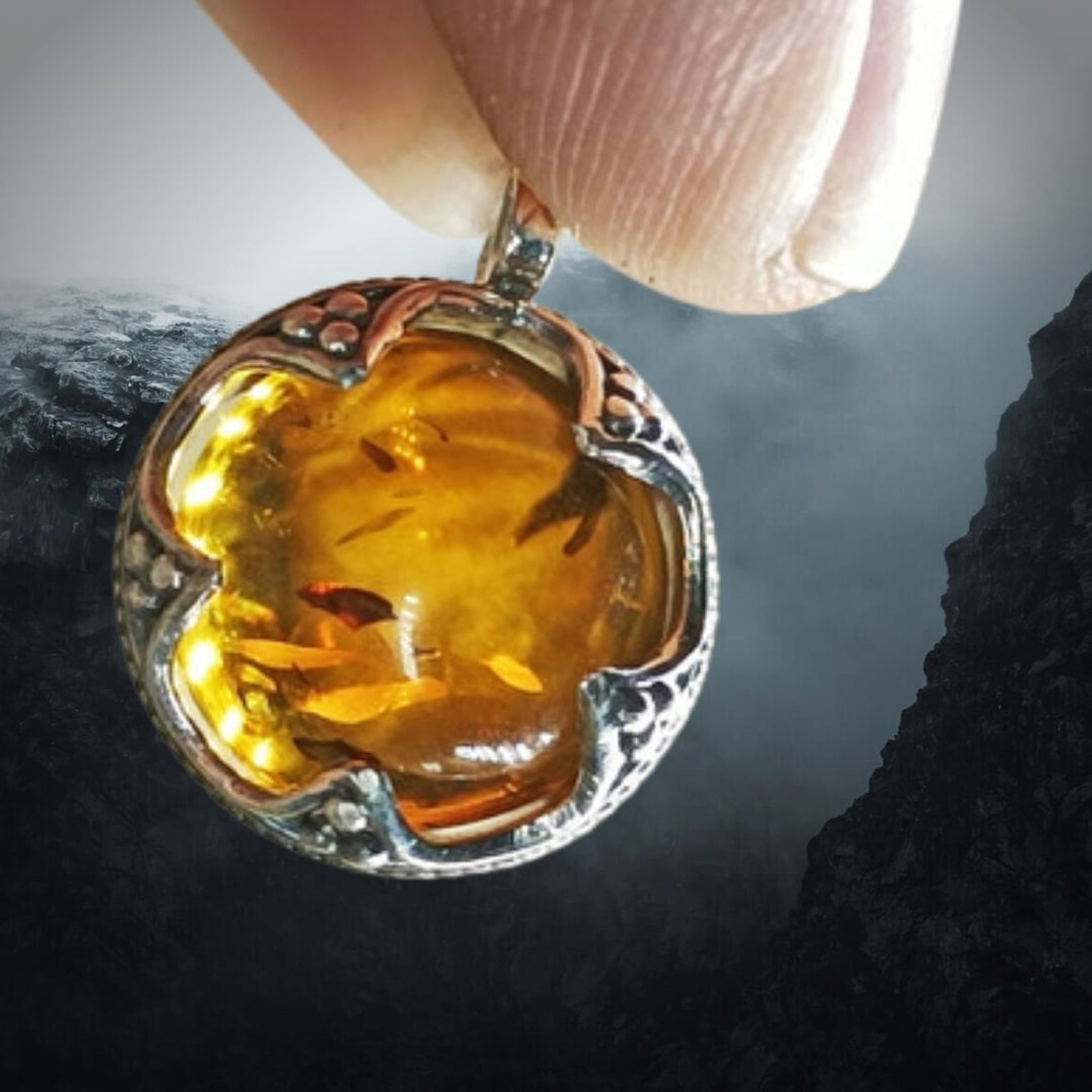 Silver Gotland Filigree Amber Ball Pendant on Icy Ridge Background