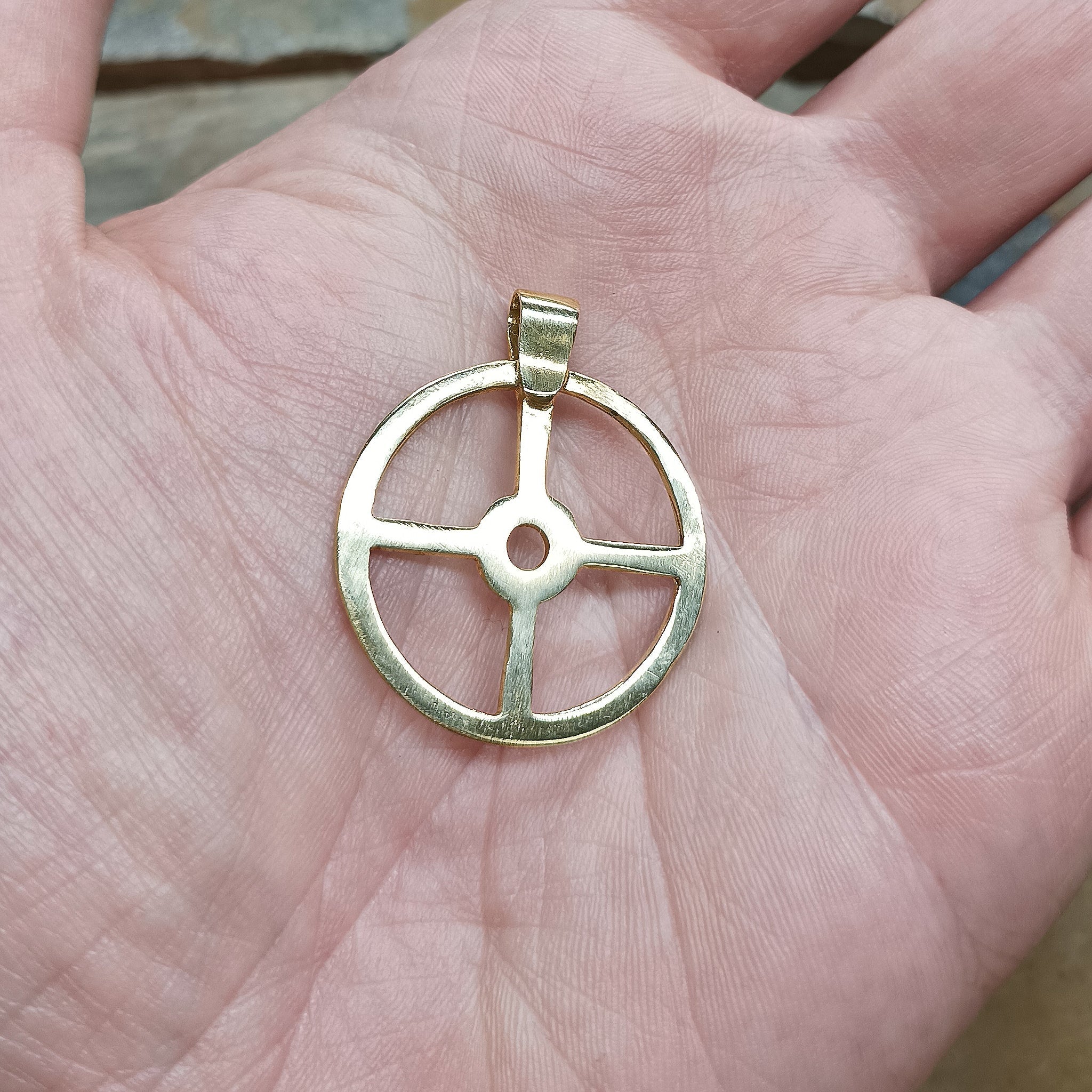 Large Brass Sun Cross Odin Pendant on Hand