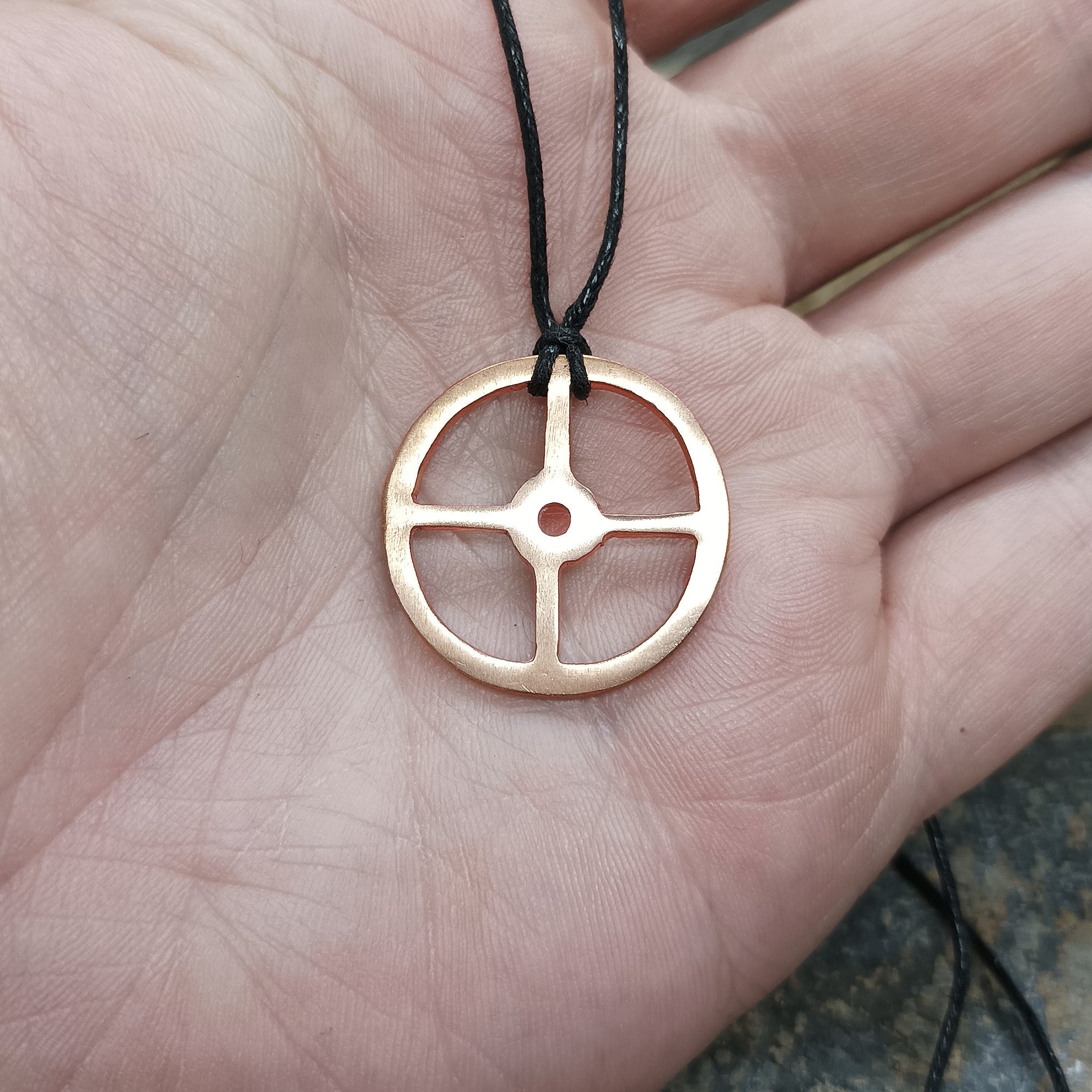 Bronze Sun Cross Odin Pendant on Hand