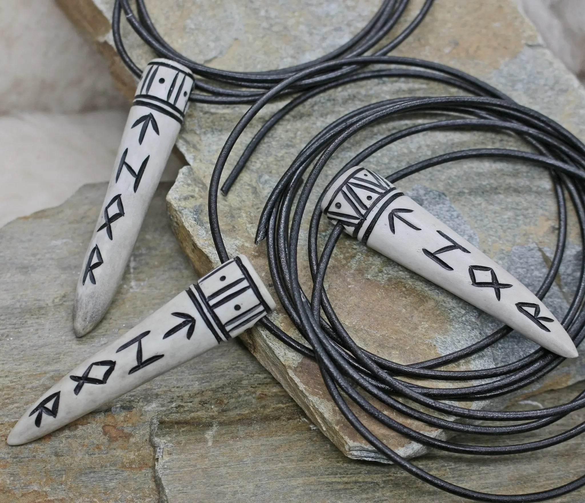Thor Antler Runic Pendants on Leather Thongs on Rock