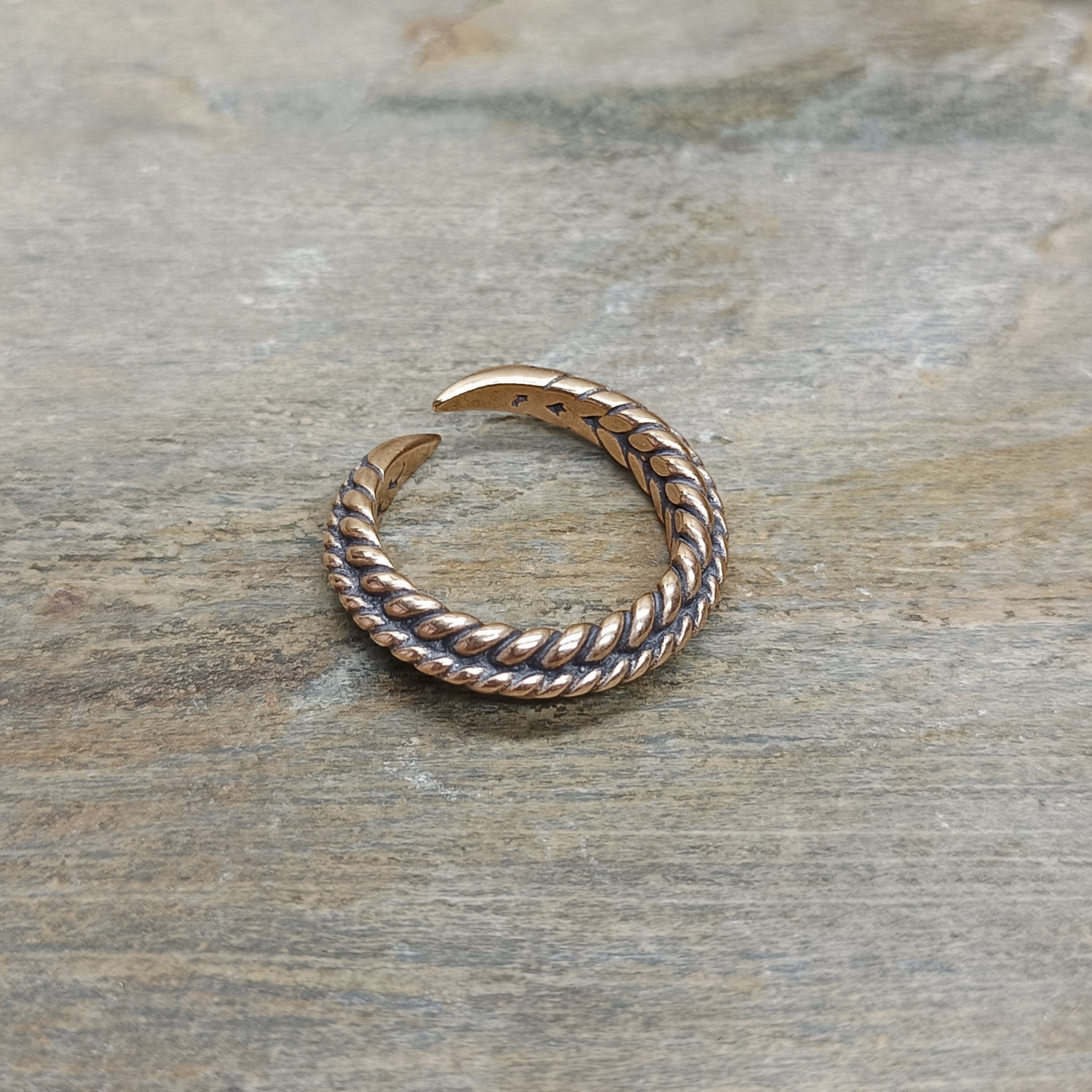 Bronze Braided Viking Ring on Stone - Front Angle View