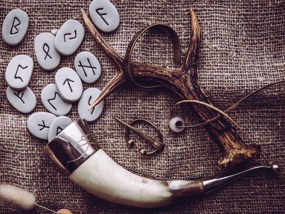 What does the Old Norse word Viking mean? Drinking horn with runes and trinkets