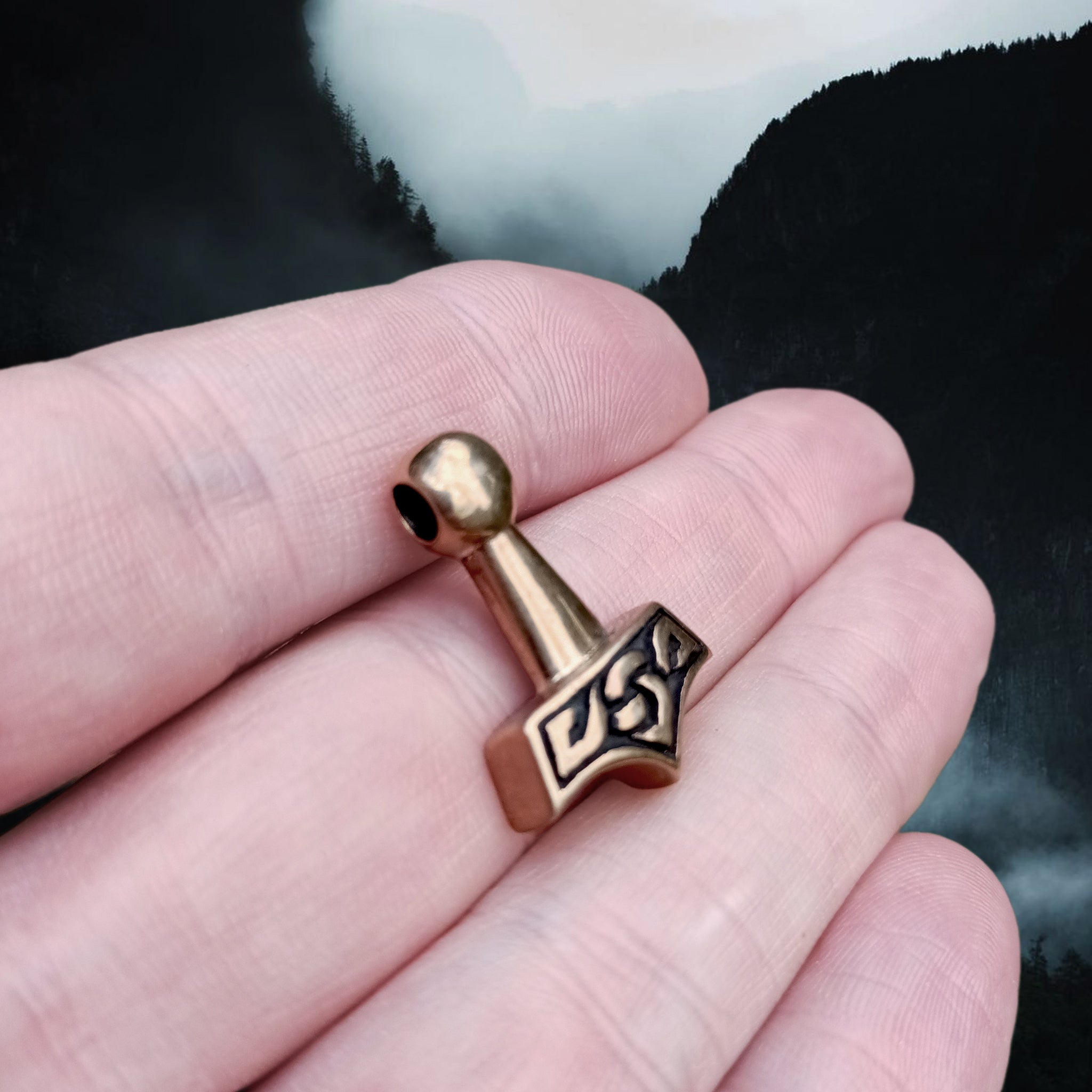 Small Bronze Knotwork Thors Hammer Pendant on Hand - Angle View