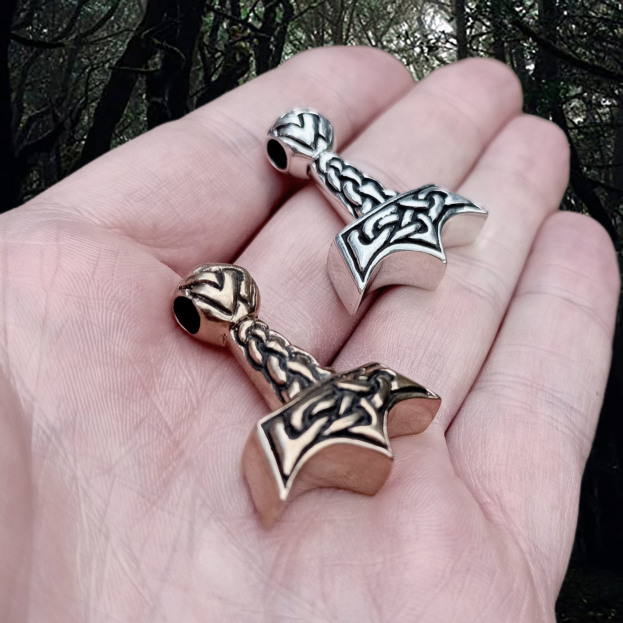 Knotwork Viking Thors Hammer Pendants in Bronze and Silver on Hand - Side Angle View