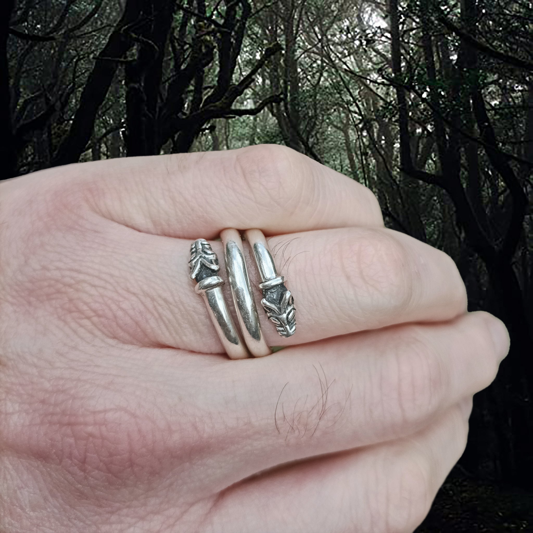 Sterling silver spiral ring with two Icelandic Viking wolf heads 0n Hand