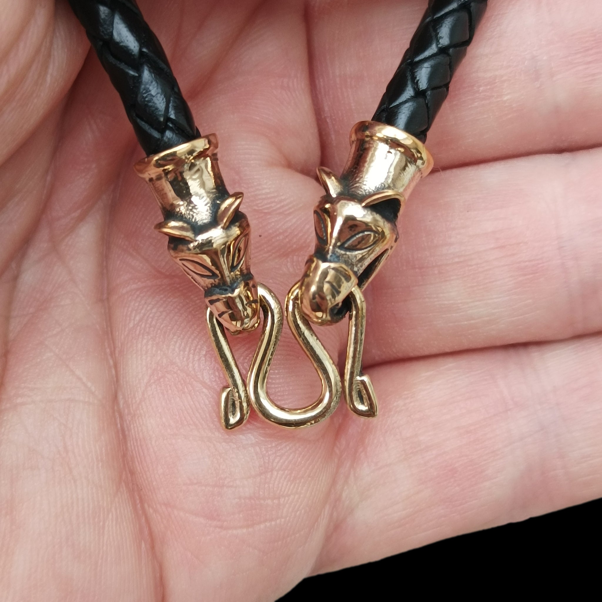 5mm Width Braided Leather Necklace with Bronze Icelandic Wolf Heads and Butterfly Fitting in Hand