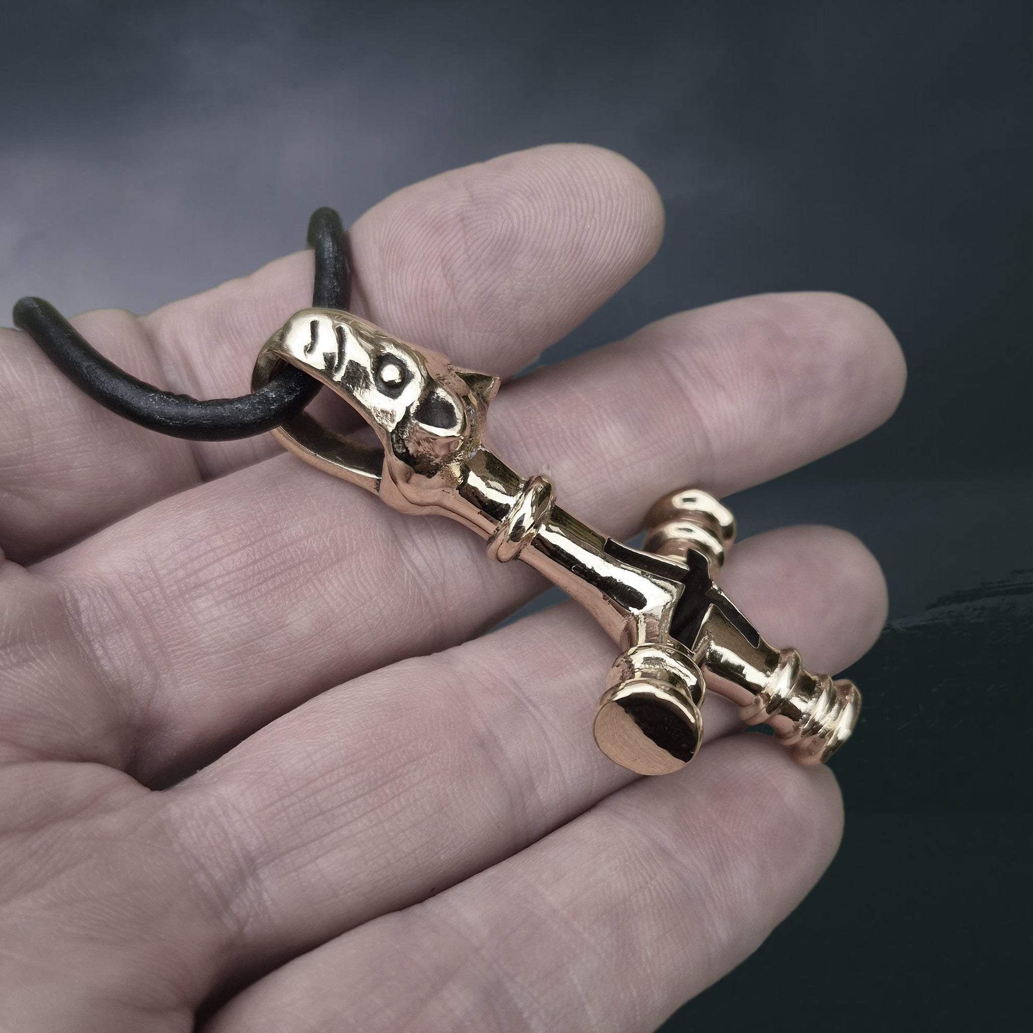 Large Bronze Icelandic Wolf Thor's Hammer Pendant Replica on Thick Leather Cord, On Hand - Side Angle View