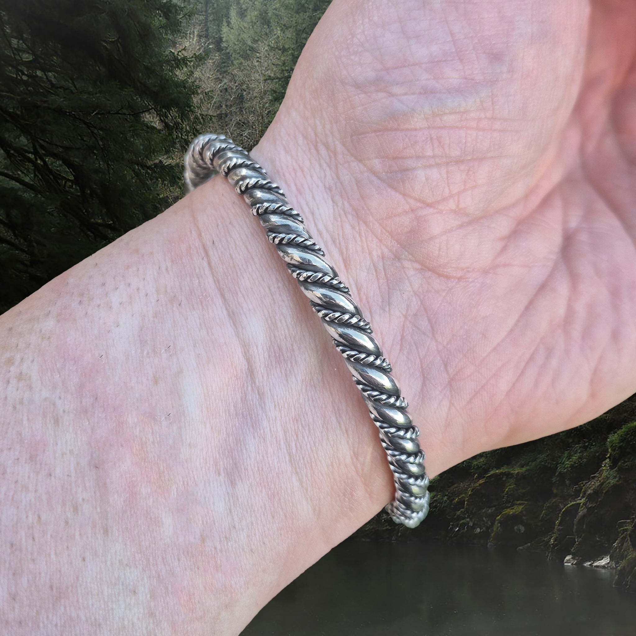 6mm Thick Twisted Silver Bracelet With Gotlandic Dragon Heads on Wrist - Back View