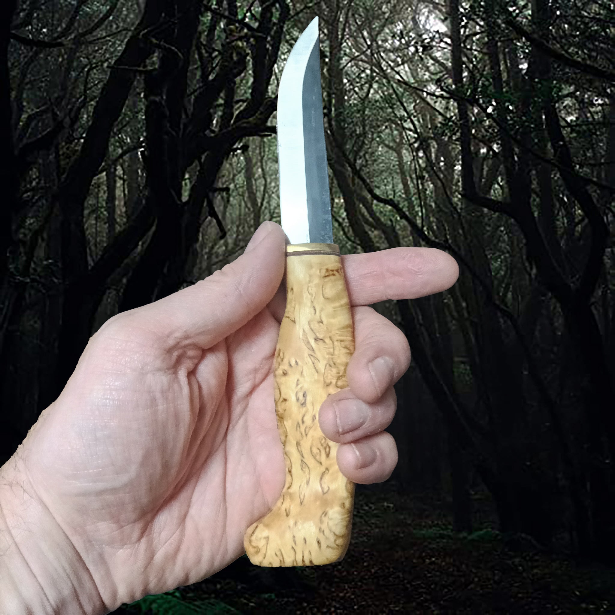 Finnish Puukko Hunting Knife with Curly Birch Handle in Hand