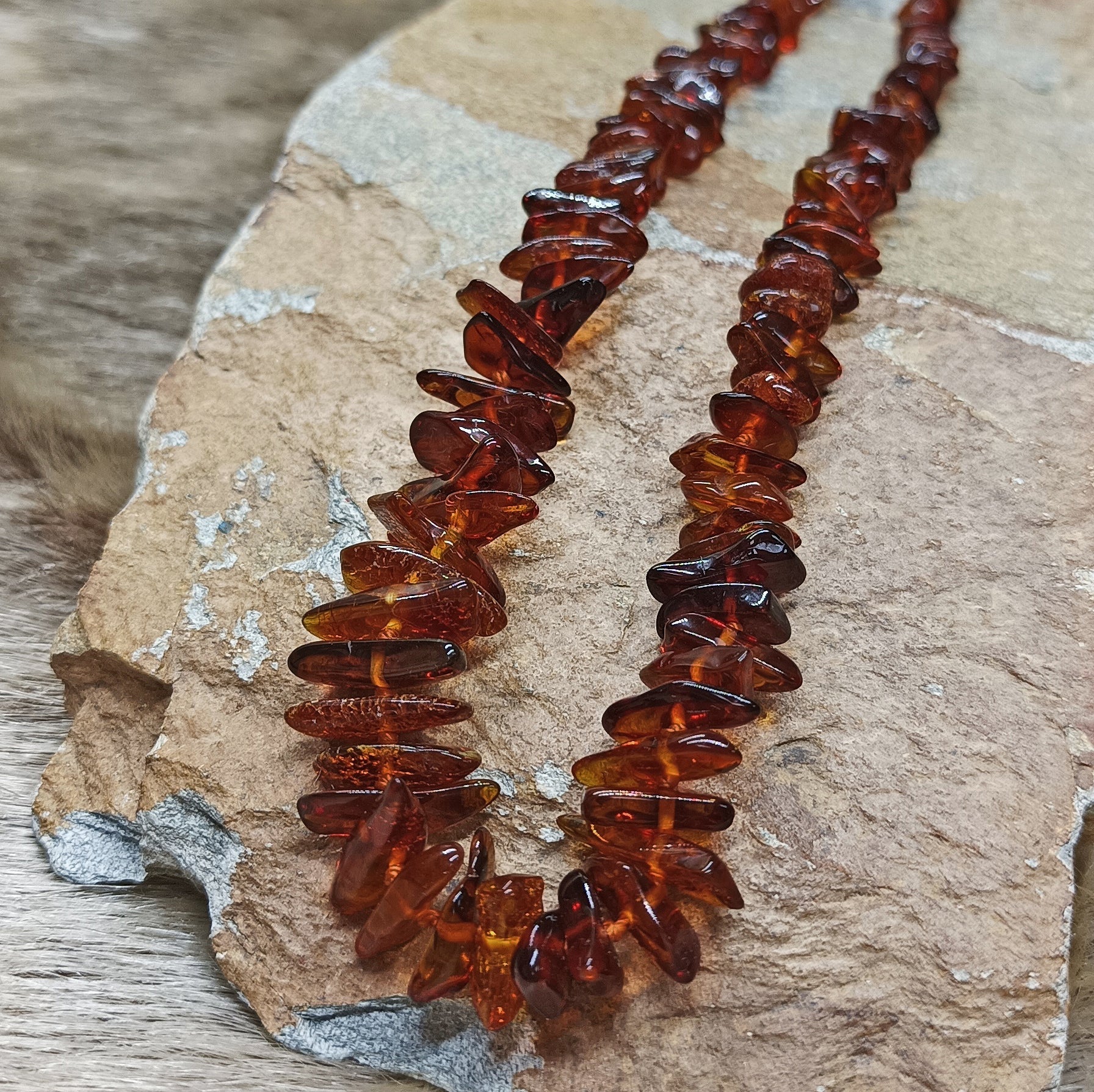 Amber Viking Necklace, Made From Cut and Polished Dark Amber Chips on Rock - Close Up