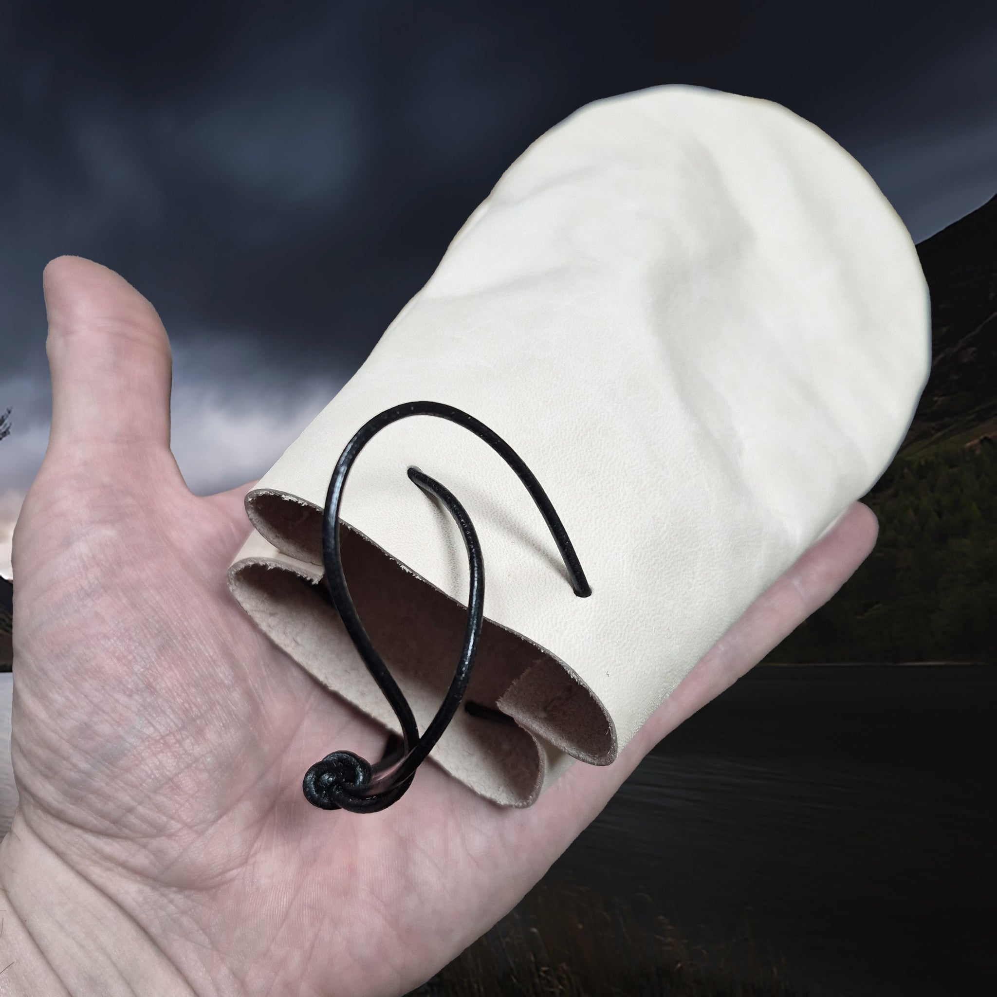 Medium Sized Natural Veg-Tan Leather Viking Pouch with Leather Drawstring on Hand - Angle View