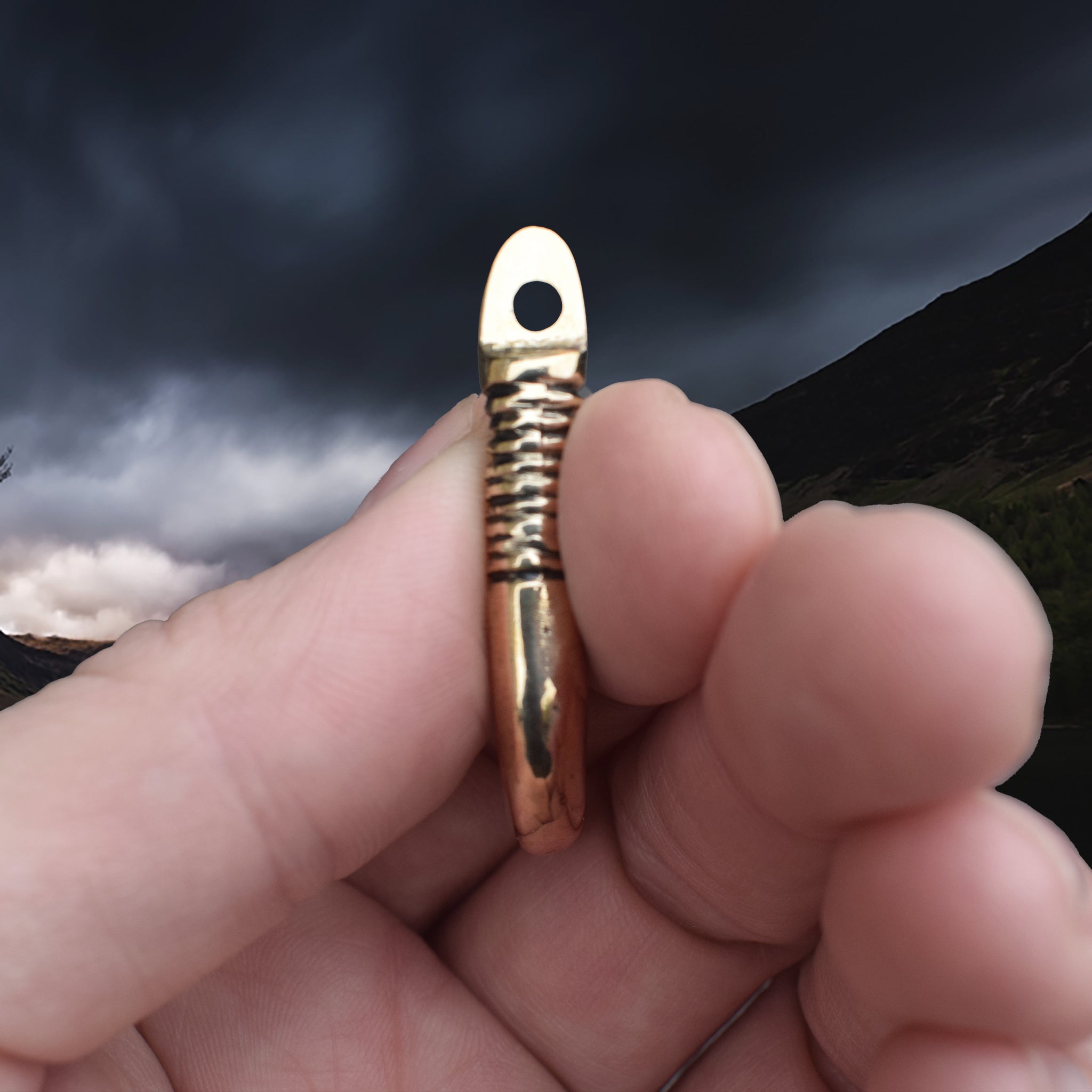 Solid Bronze Replica Viking Bear Tooth Pendant from 9th to 11th century Finland in Fingers - Side View