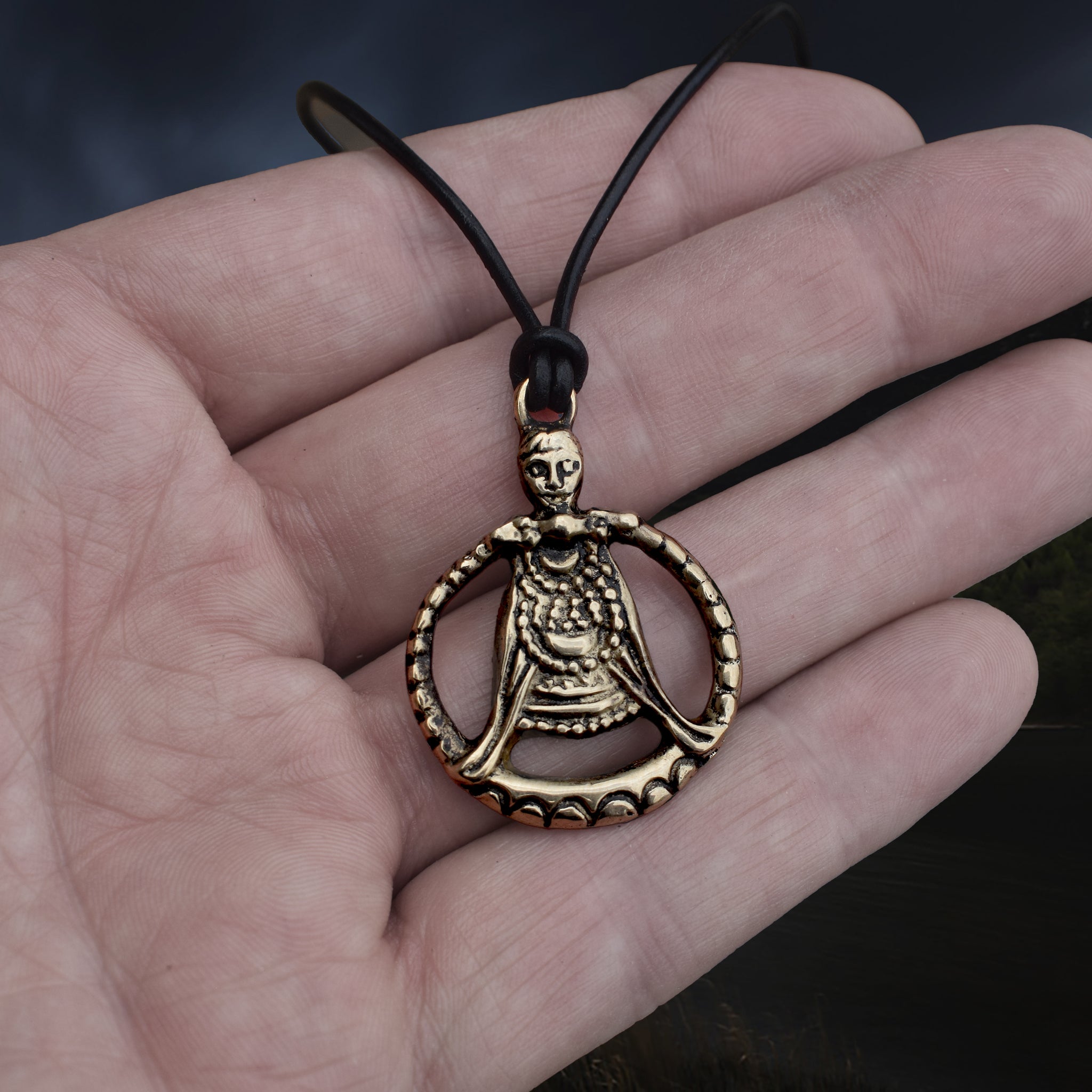 Large Bronze Circular Freya Pendant Replica with Top Loop on Leather Cord, on Hand