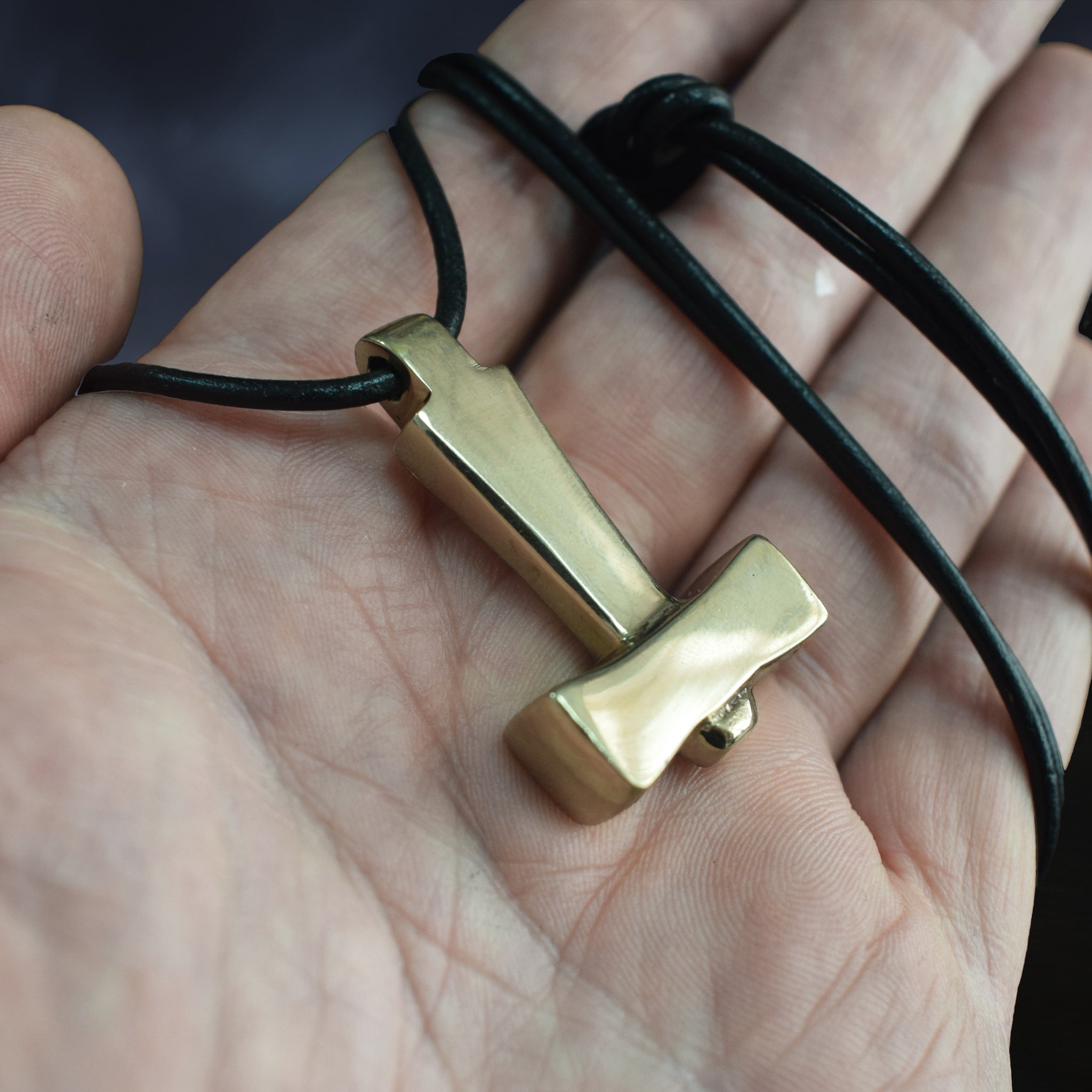 Bronze Replica Thors Hammer Pendant from Läby, Sweden on Leather Cord, on Hand - Angle View