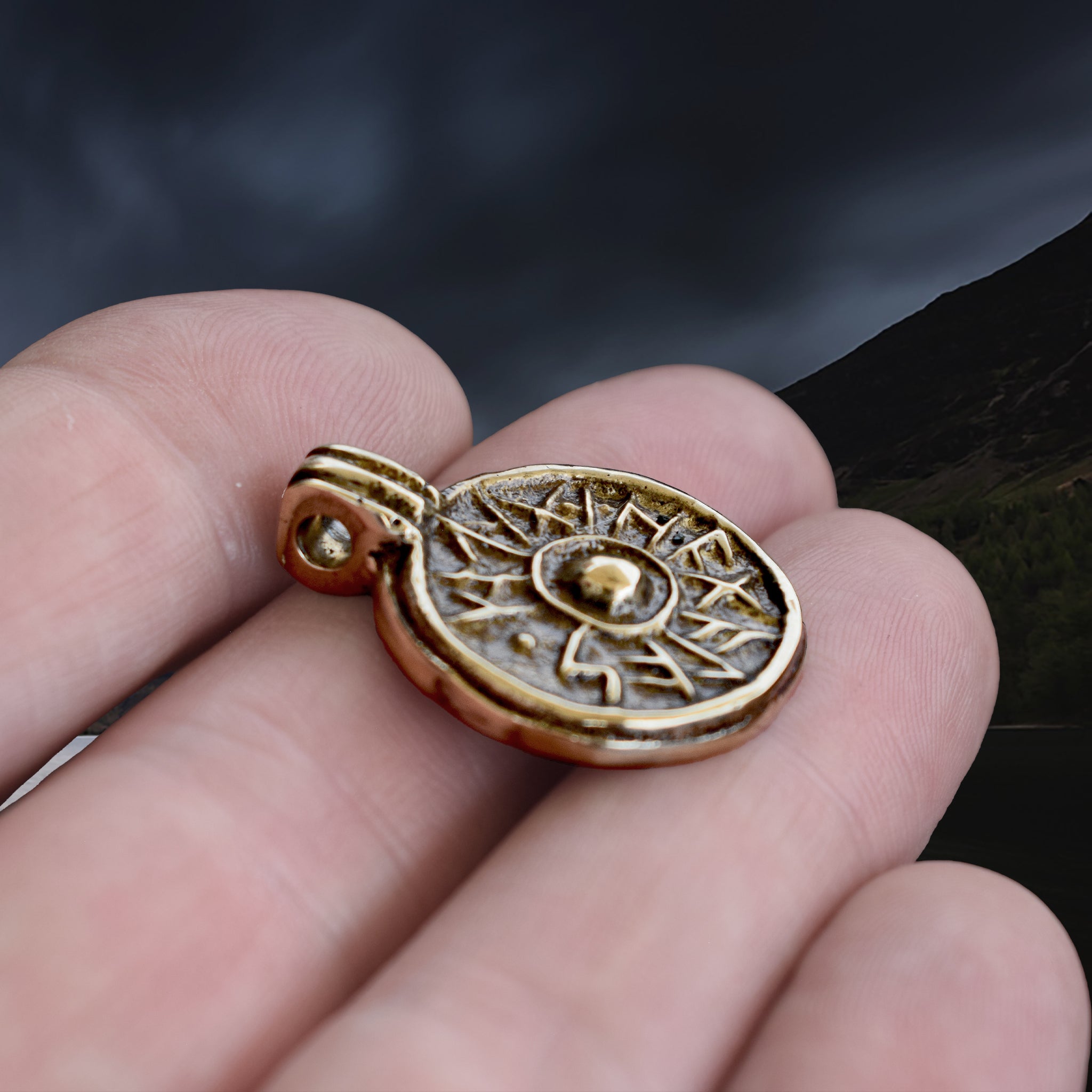 Bronze Round Replica Viking Luck / Good Health Pendant on Hand - Side Angle View