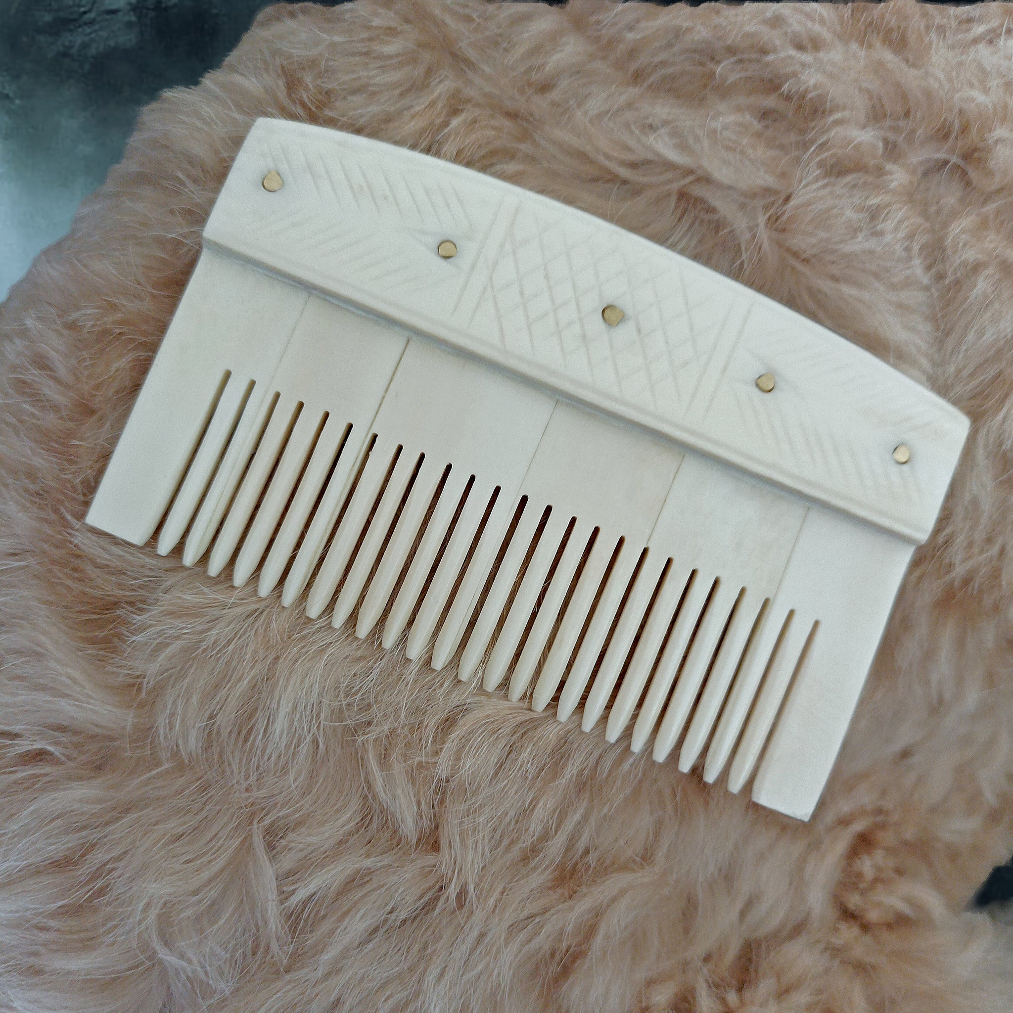 Decorated Bone Viking Comb with Rivets on Teddy