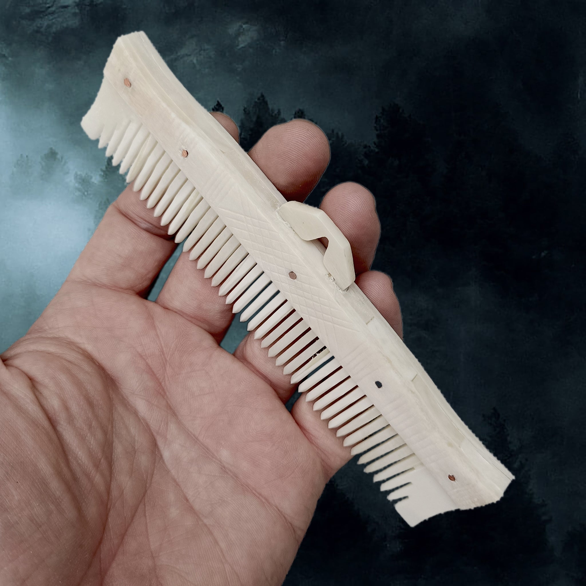 Long Decorated Bone Viking Comb with Hanger in Hand - Side Anlge View