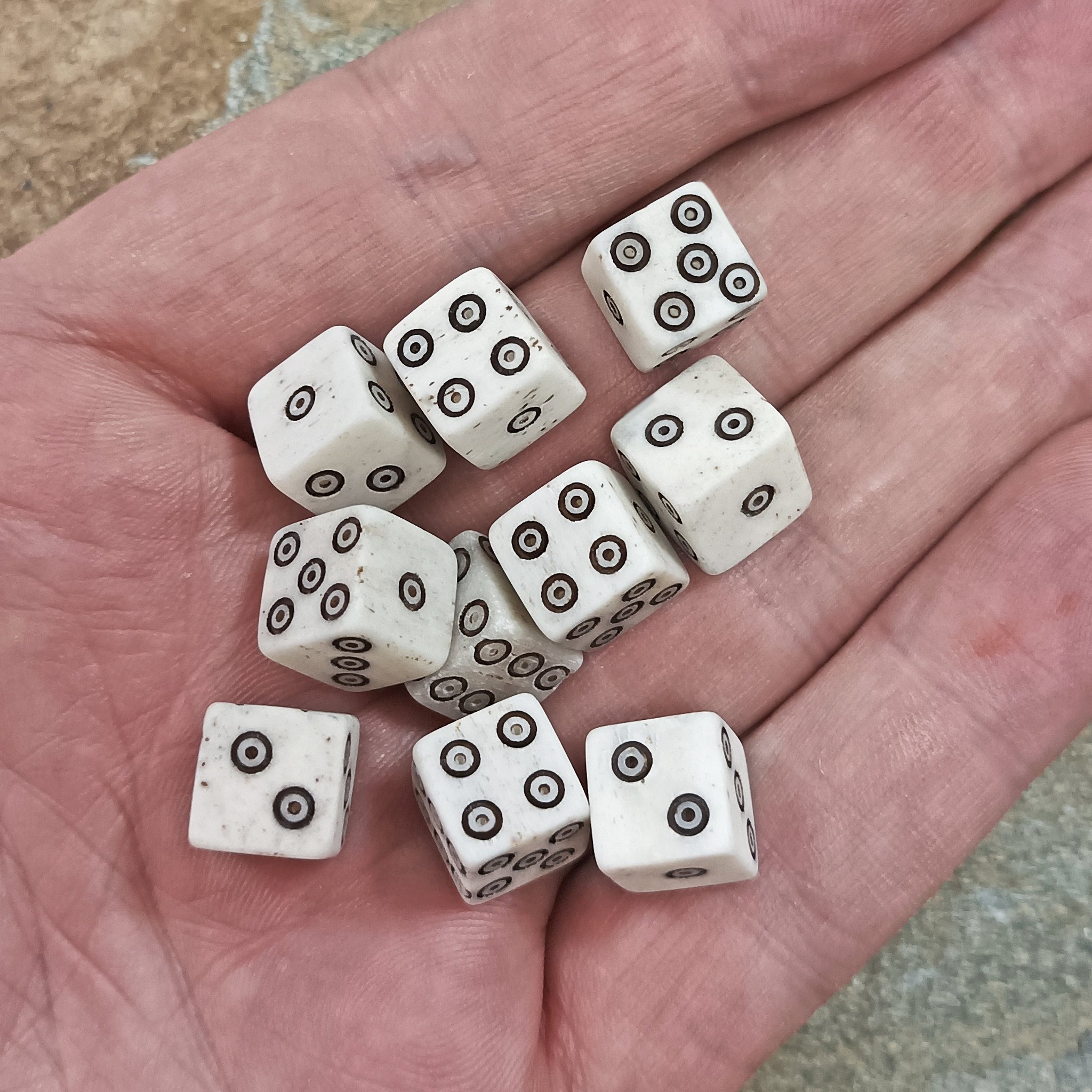 Small Natural Bone Replica Viking Dice with Black Dot and Ring Incised Spots in Hand x 10