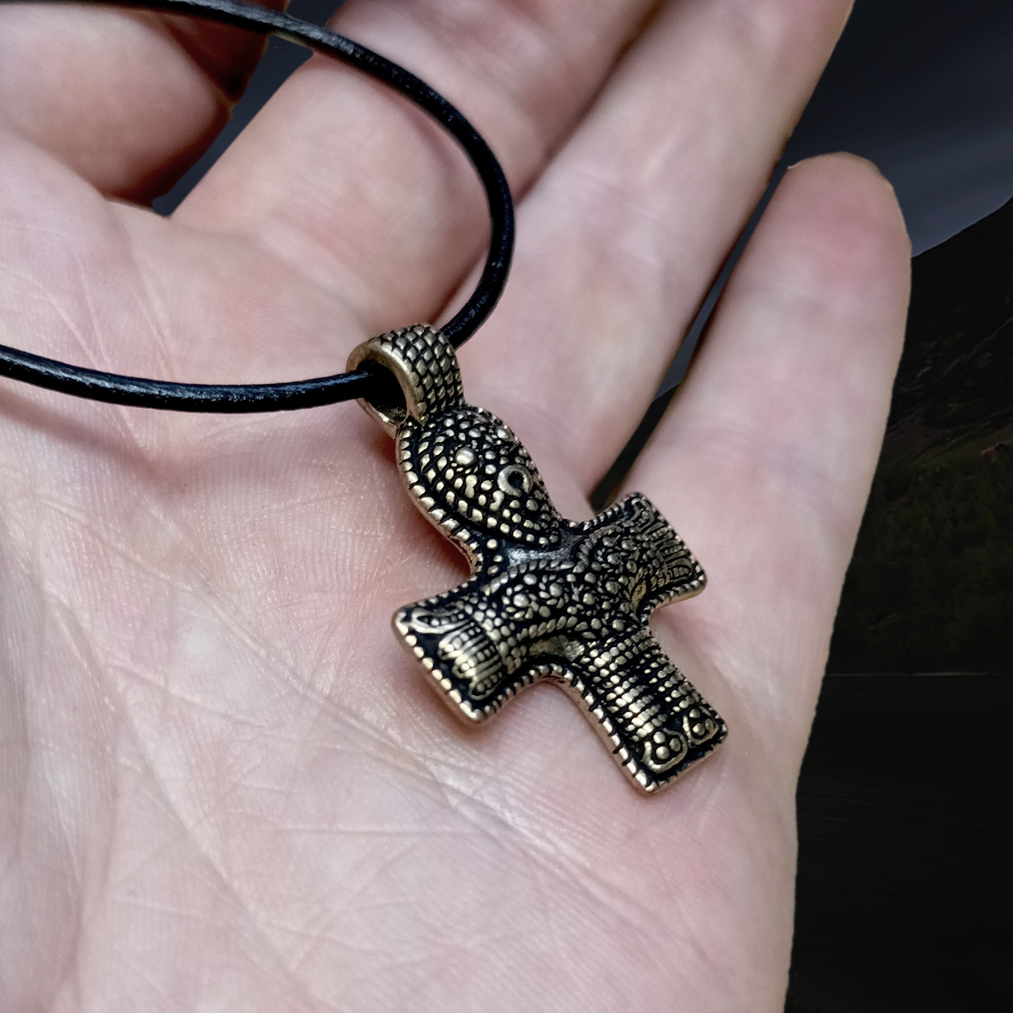 Bronze Crucifix Pendant from Denmark on Leather Thong, On Hand - Angle View - Viking Jewelry