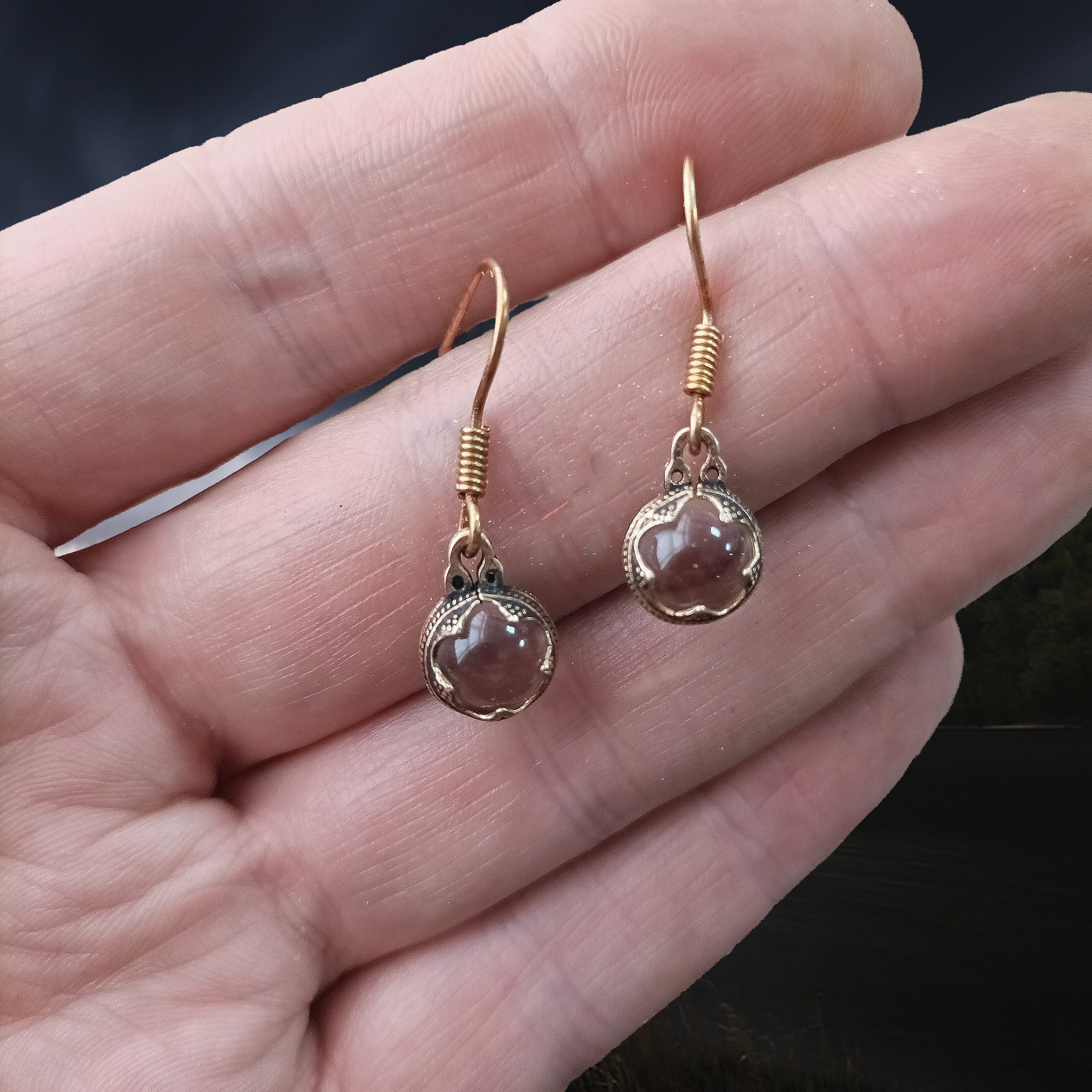 Gotlandic Crystal Ball Viking Earrings Suspended From a Bronze Wire with Decorated Bronze Casing on Hand