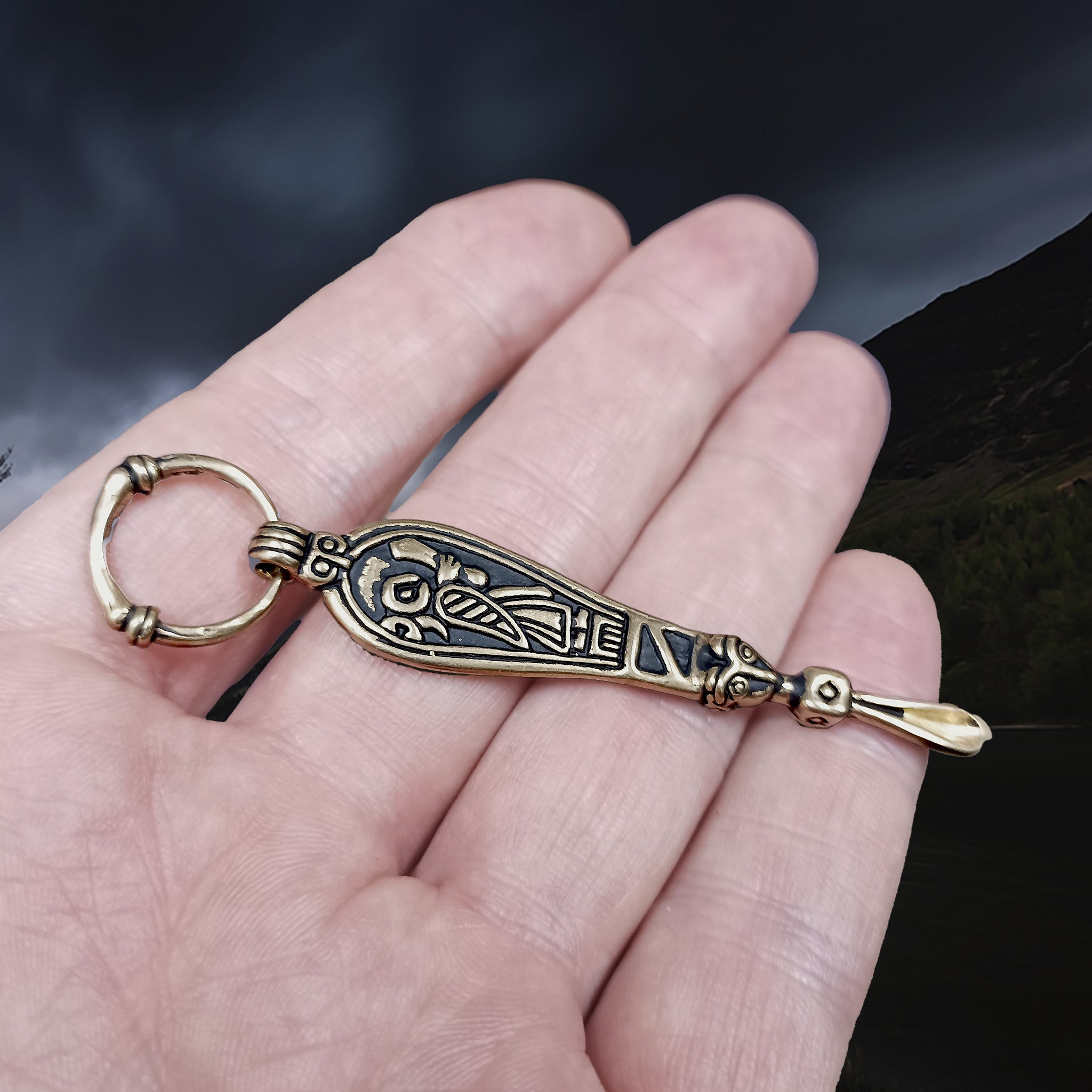 Bronze Ear Spoon Viking Pendant with Ring Hanger on Hand - Angle View