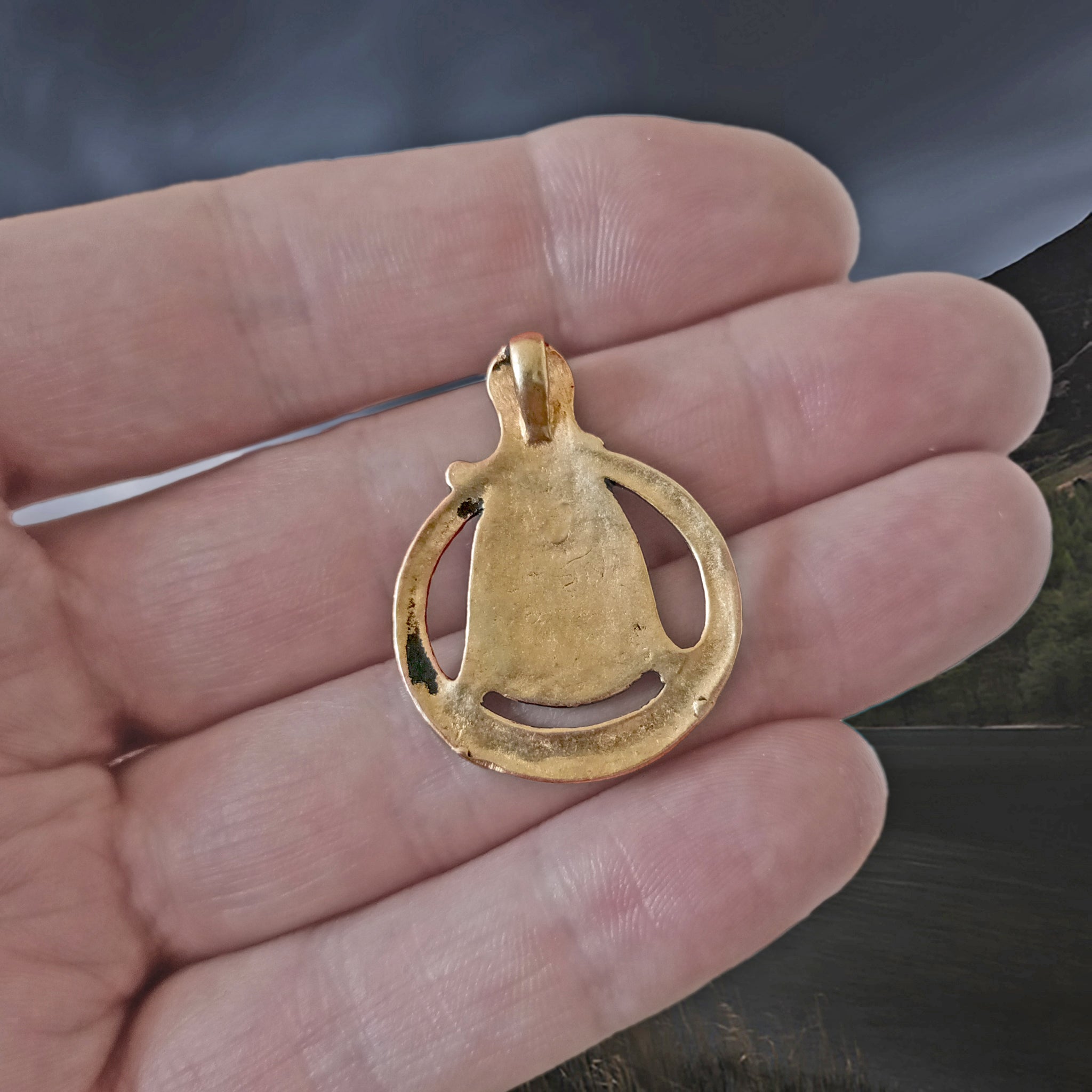 Large Bronze Circular Freya Pendant on Hand - Back View