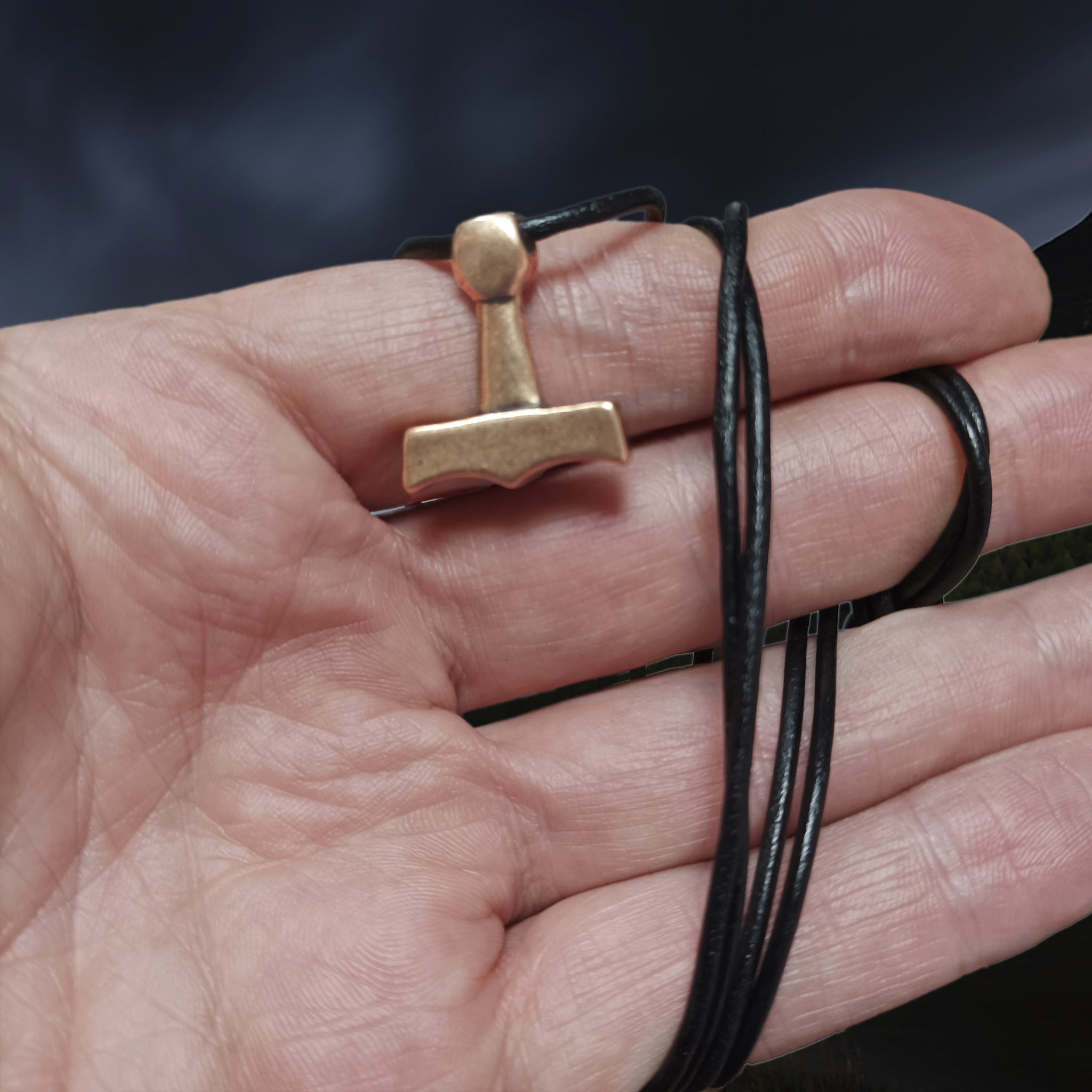 Small Bronze Replica Viking Thor's Hammer Pendant from the Island of Sejerø, Denmark on Leather Cord, on Hand