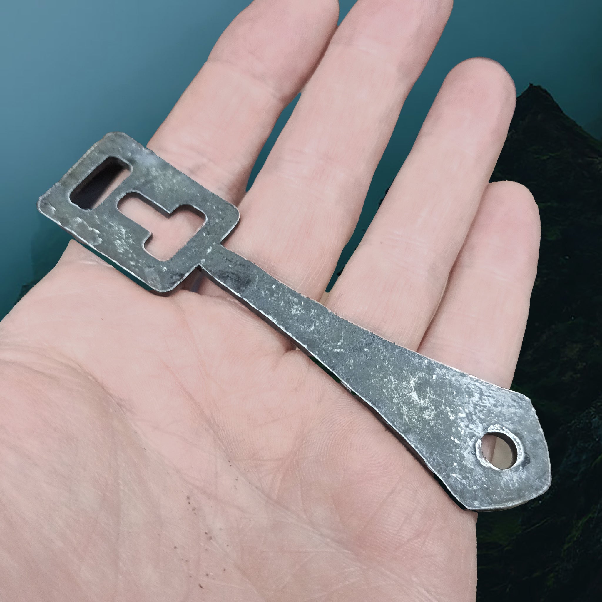 Hand-Forged Replica Viking Steel Padlock Key on Hand - Angle View