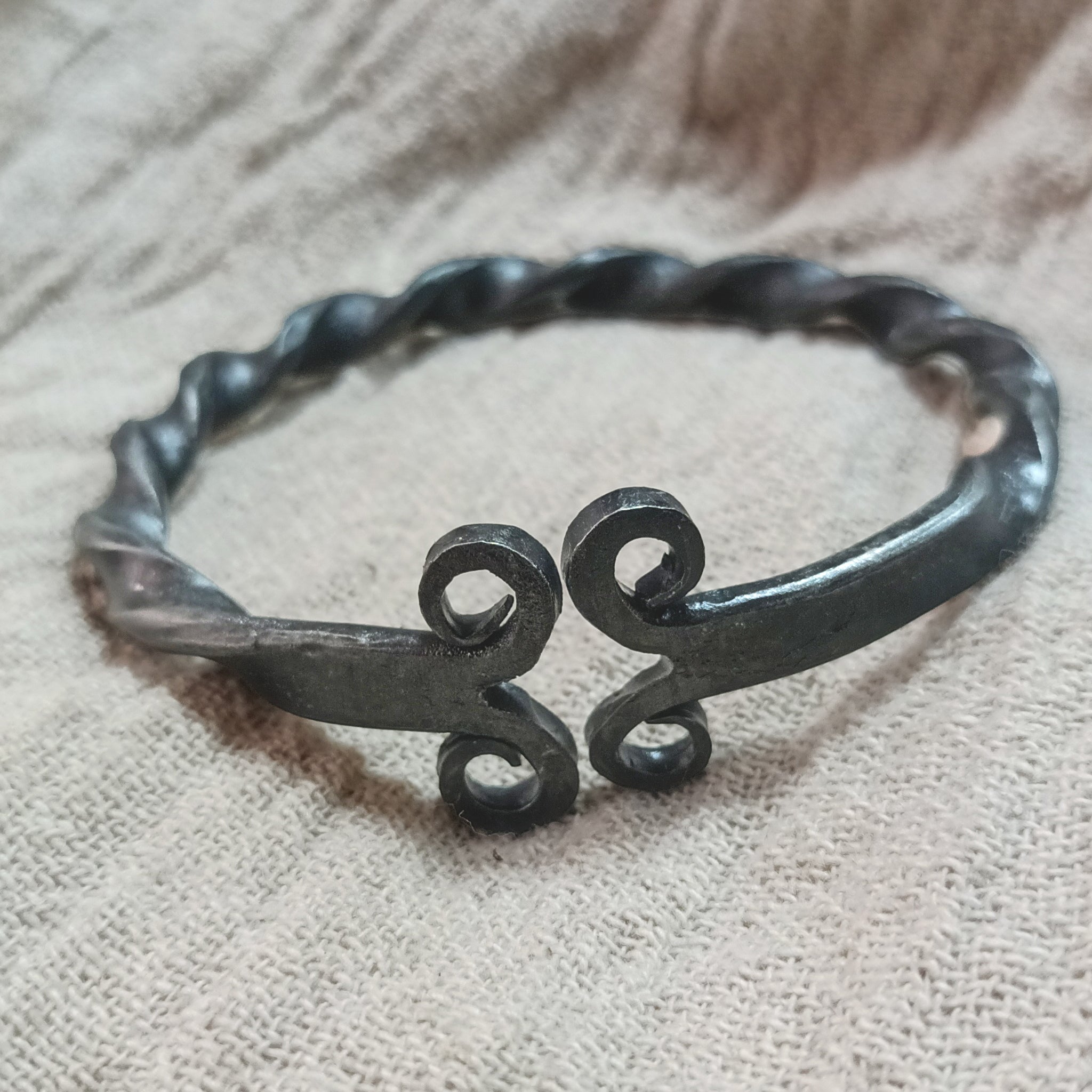 Twisted Iron Viking Bracelet / Arm Ring on Linen - Front View