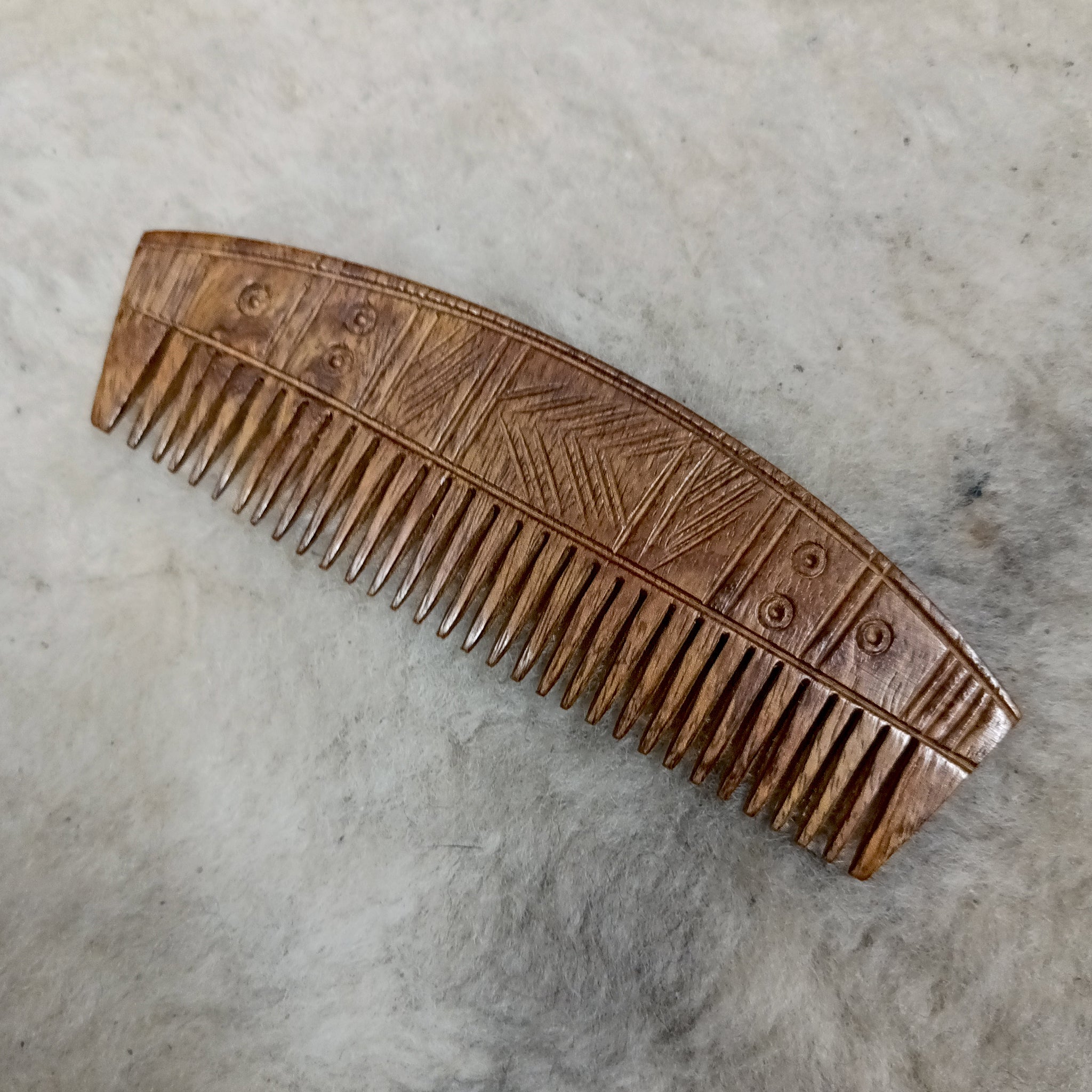 Decorated Wood Viking Comb with Curved Back on Wool