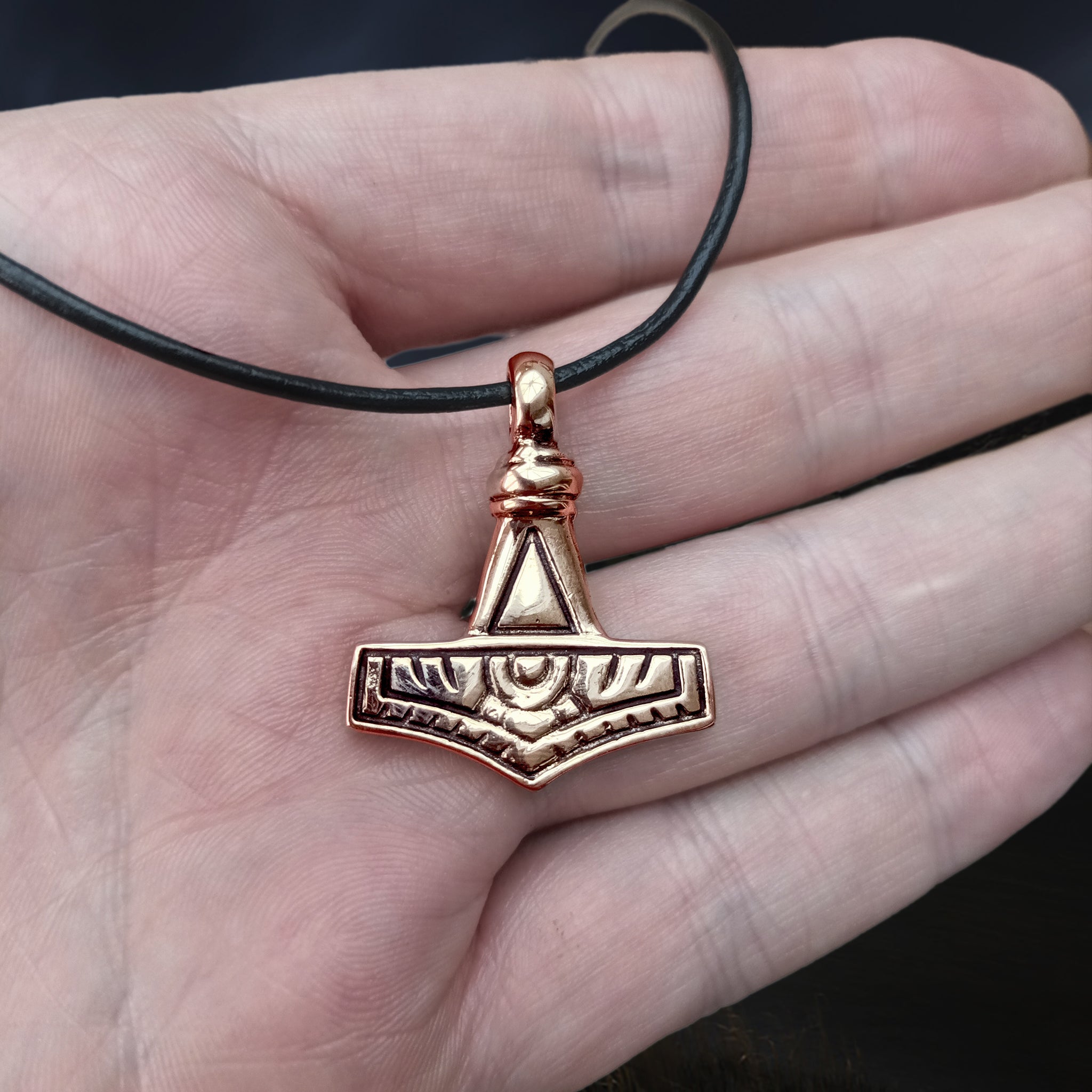 Bronze Gotland Replica Thors Hammer Pendant on Hand on Leather Thong - Front View