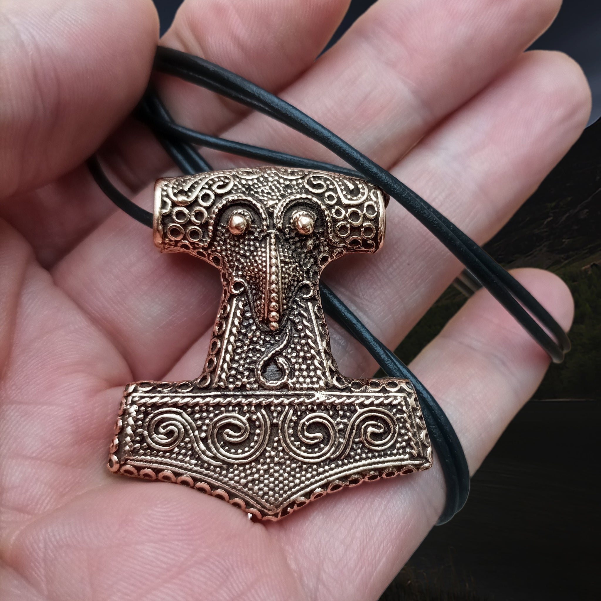 Large Bronze Skåne Thors Hammer Pendant on Thong Wrapped Around Hand