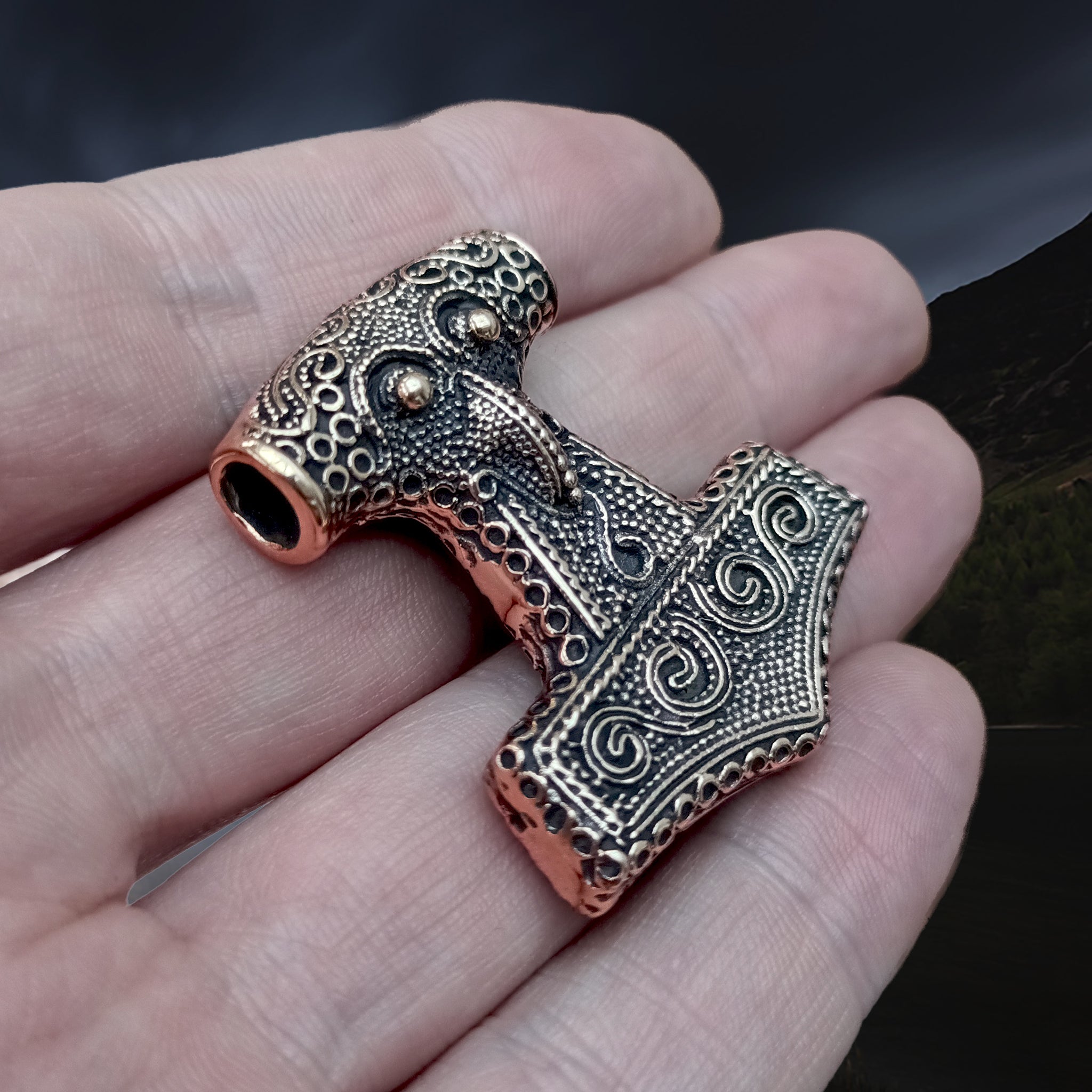 Large Bronze Skåne Thors Hammer Pendant on Hand - Side Angle View