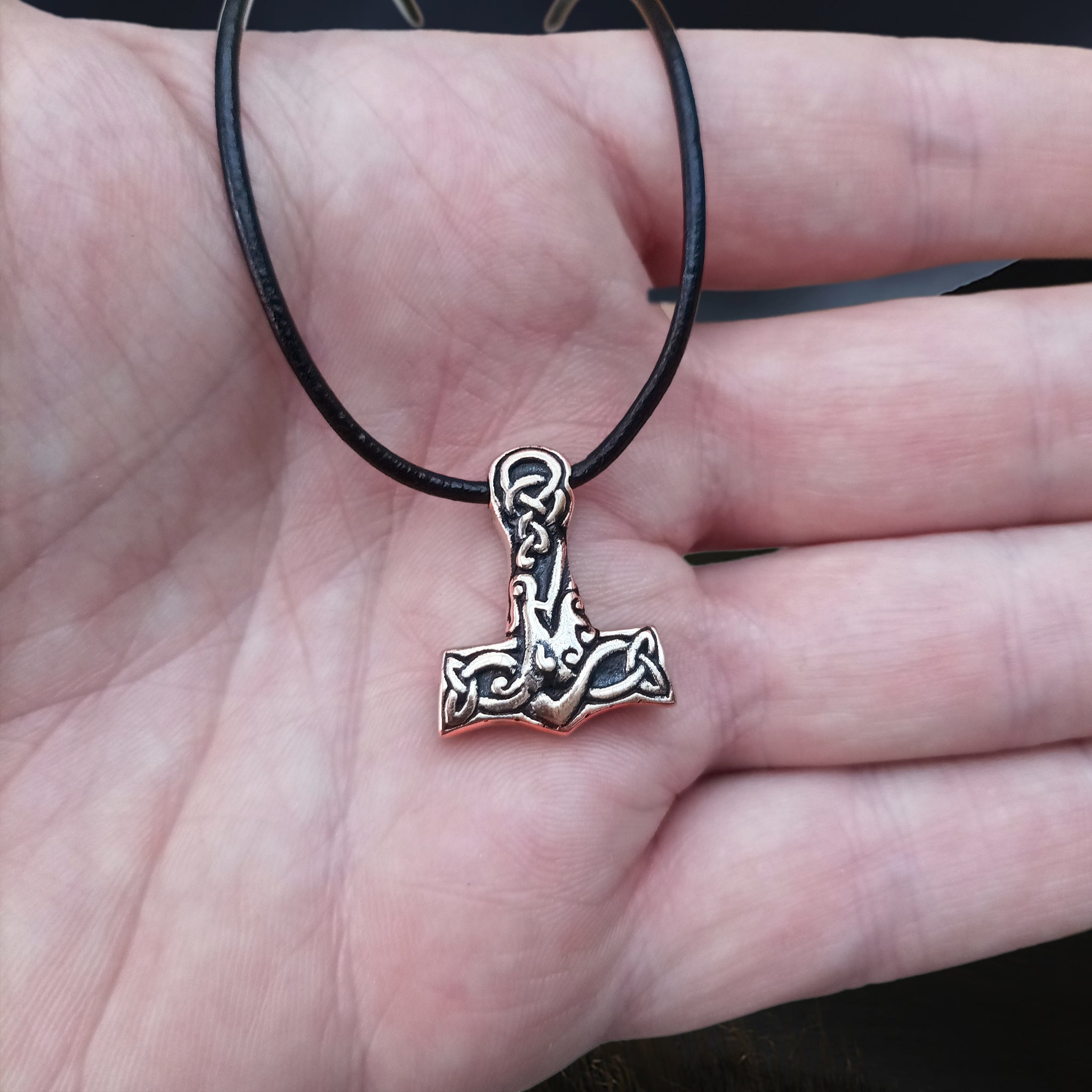 Small Bronze Interlace Thors Hammer Viking Pendant on Leather Thong on Hand
