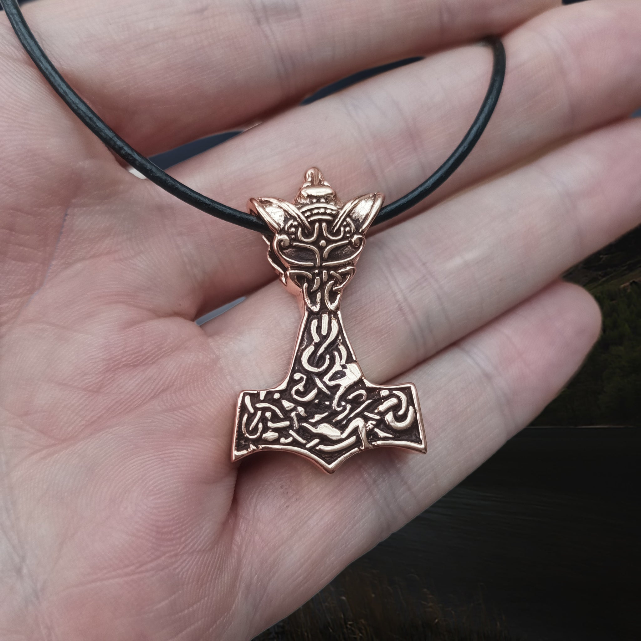Bronze Wolf Thors Hammer Pendant on Hand on Leather Thong