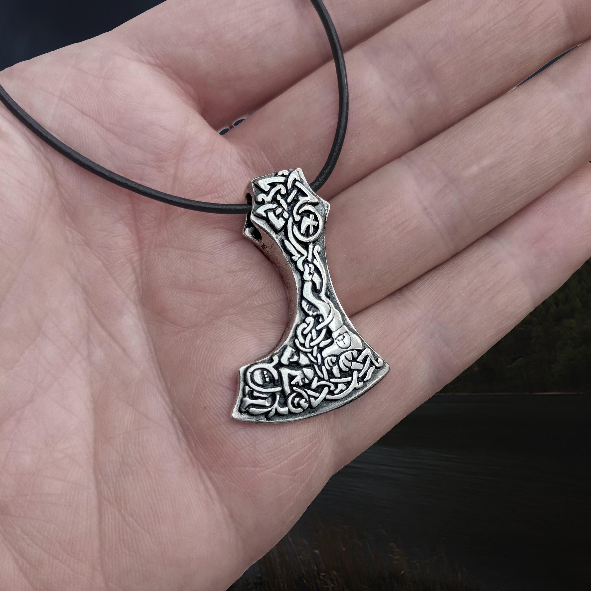 Silver Bearded Axe Head Viking Pendant on Leather Thong on Hand