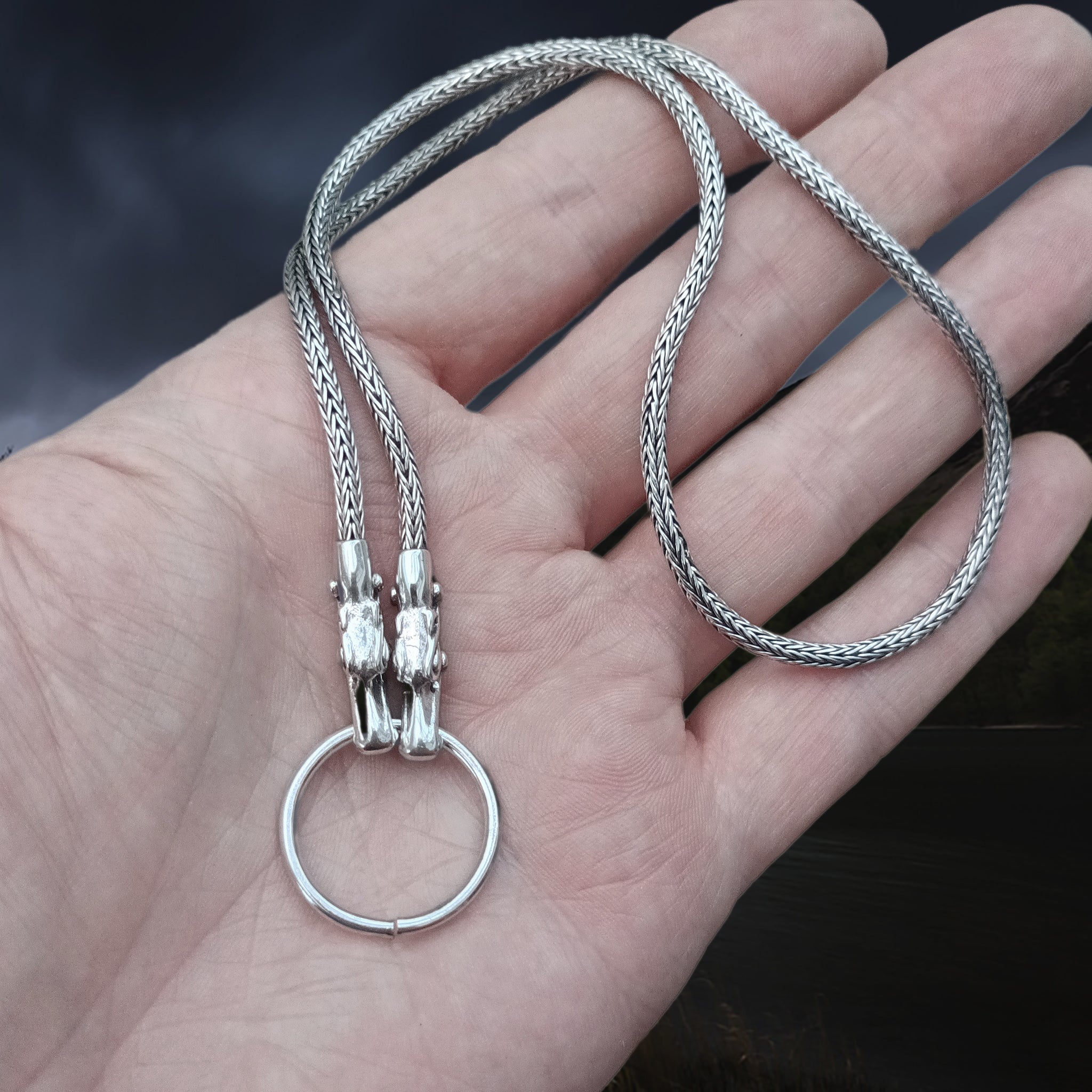 Slim Silver Snake Chain Pendant Necklace with Tromso Dragon Heads and Split Ring on Hand