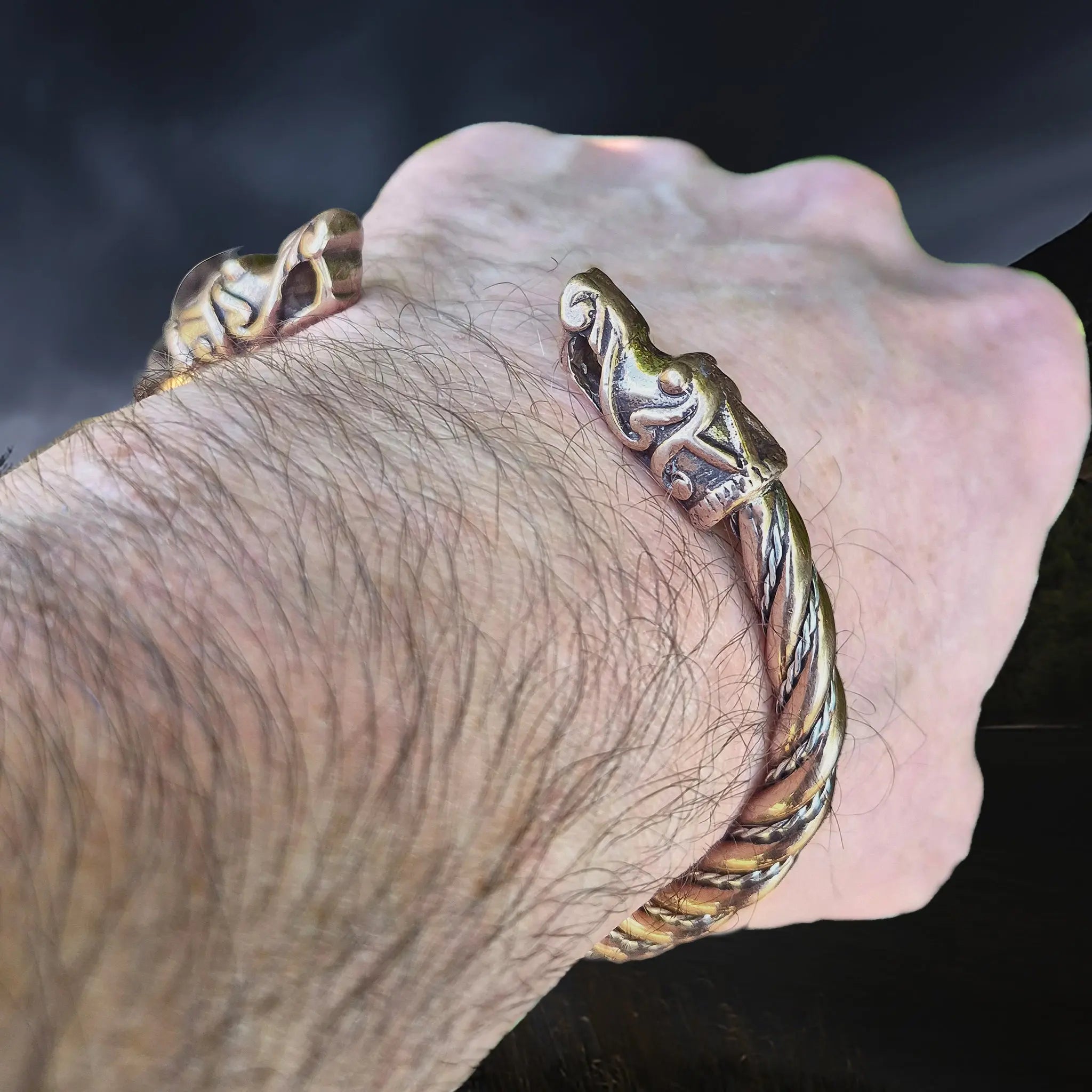 Handmade Twisted Bronze & Silver Bracelet With Gotlandic Dragon Heads on Wrist - Angle View